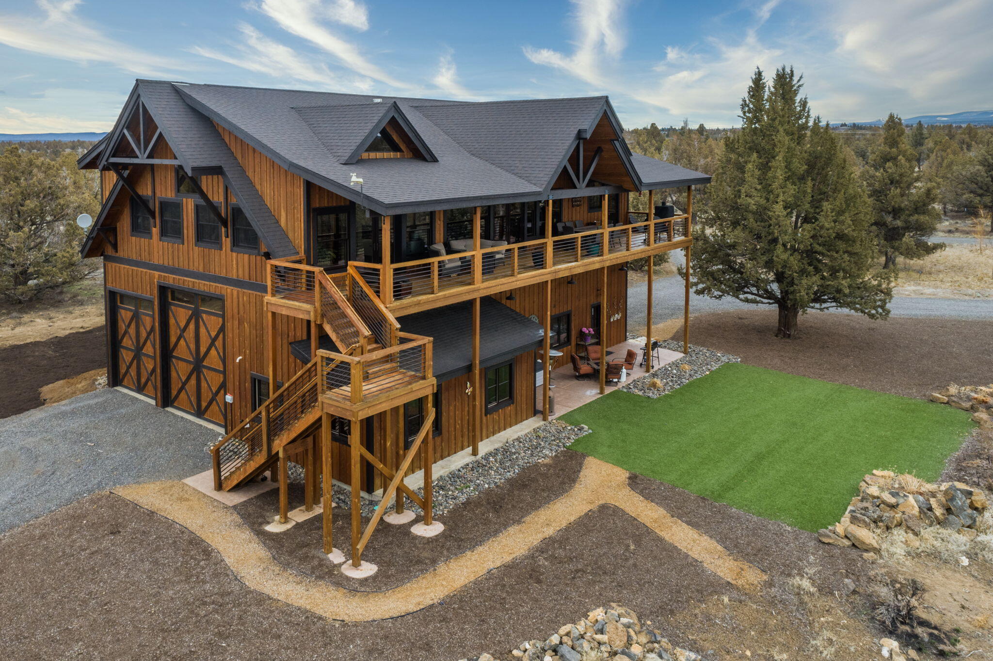 Nestled on a fully fenced 10-acre lot with breathtaking Cascade Mountain views. This home was designed with RV owners and outdoor enthusiasts in mind, the property offers pull thru RV garage, a heated shop, and guest quarters - the perfect combination for those who love to travel and explore. Additionally, a greenhouse, detached shop, and bar room to provide ample space for hobbies and entertaining. Inside the home, you'll be greeted by gorgeous, vaulted wood-beamed ceilings, adding to the spacious and open feel of the living spaces. The primary suite boasts stunning mountain views and a huge walk-in tiled shower. The kitchen features a 6-burner cooktop, Fisher Paykel 2-drawer dishwasher, breakfast bar, pantry, and soft-close solid hickory cabinetry with upper and lower cabinet lighting. Don't miss out on the opportunity to own your dream home in Beautiful Bend, Oregon, offering the perfect combination of luxury, comfort, and outdoor adventure.