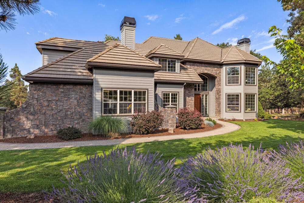 This SPACIOUS 3,700 square foot home at the Running Y Resort offers 4 bedrooms and 3 full baths. Quality throughout, the custom rooms are oversize, and the living spaces are flexible. Main level boasts a bedroom, full bath, office, living room, dining room and kitchen and TV/sitting area with dry bar. The upper level has 3 bedrooms, to include a primary suite with gas fireplace and elegant master bath. Conveniently located on the upper level, the laundry room separates the main bedroom from the 2 additional bedrooms and upstairs great room with gas fireplace.  Mature landscaping and shade trees complement this classic home. With an oversize 3 car garage and work bench, there is abundant storage in the home that includes 3 mini storage areas. Soaring ceilings and 8-foot doors accentuate the spacious feel of this light filled home. You have to love the level driveway! Cinnamon Teal is not a through street and has access to one of the most scenic hiking trails in the resort.