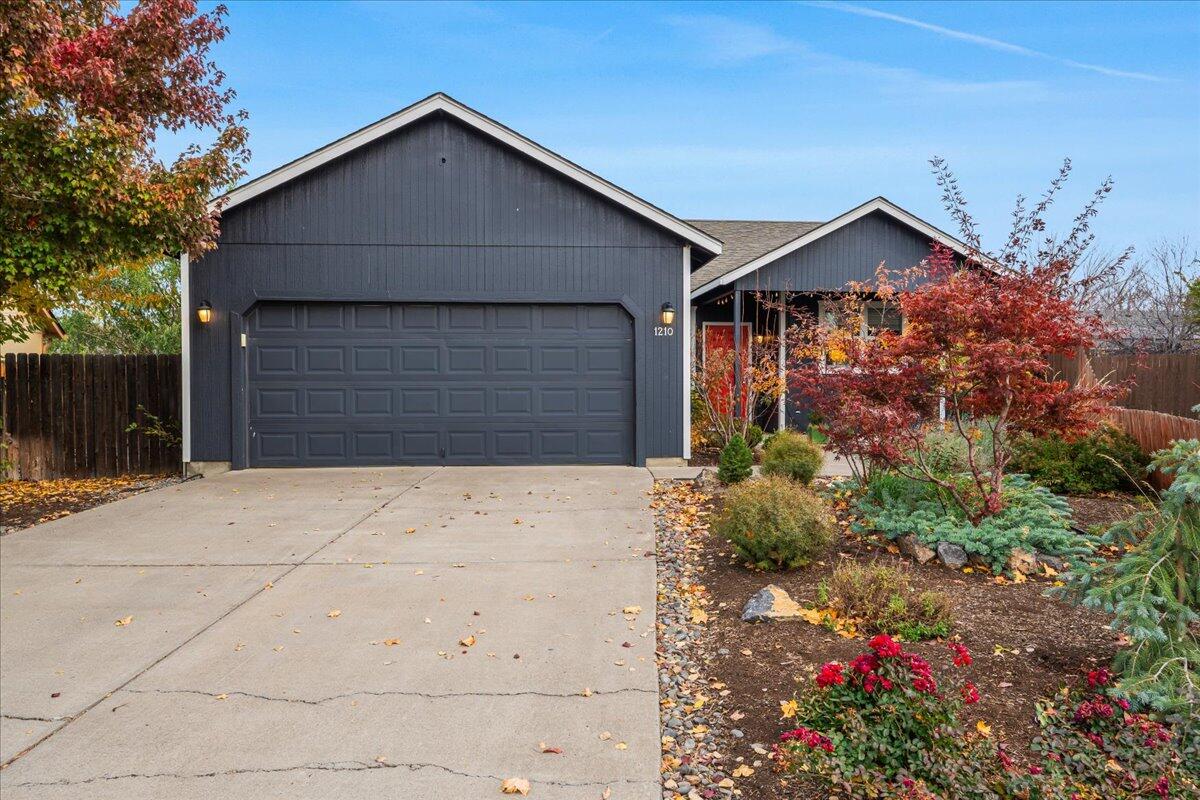 Flooded with natural light and tucked at the end of a quiet cul-de-sac, this peaceful home blends style and intention in every detail. Fresh exterior paint, newer stainless appliances, a new water heater and a mini-split system for heating and cooling make it effortless to live in and love. Primary spacious bedroom offers a large walk-in closet, while big windows bring the outdoors in. Step into a truly special yard—every inch designed for beauty and purpose. Enjoy established trees, native plants raised veggie beds, grapes and a drip system that keeps everything thriving with ease. gated gravel parking for an RV or toys, separate from the main yard. Gather around the firepit or relax on the front porch surrounded by lush greenery. Private, sunny and full of Central Oregon charm.