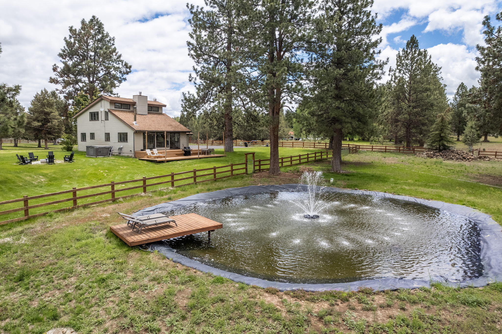 This fully fenced and gated green acres with towering pines can be accessed through two private roads, one of which is paved. Charming renovated home is nicely perched, taking in mountain views, water feature and pasture. Light and bright with high ceilings, hardwood floors and cozy certified wood stove. 4.78 acres with four acres of water rights. Newer barn is 46x60 with 20x60 finished and heated space.  Room for all the animals! RV parking, dump, water and 30 amps. Nicely landscaped with 5-zone sprinkler system. Hot tub and new fire pit. Seller has architectural plans drafted by Shelter for addition to the home.