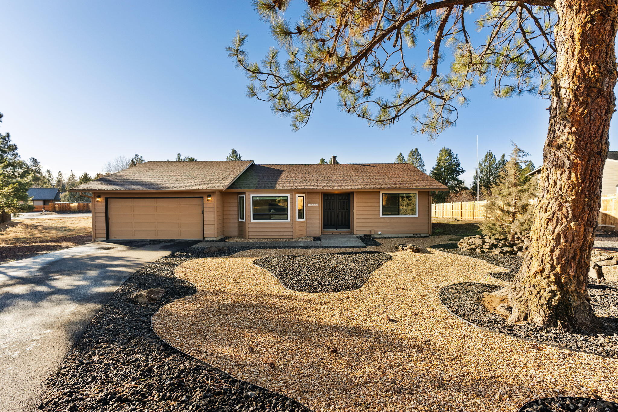 Beautifully renovated half-acre property with extensive 2025 updates throughout. Improvements include a new electric furnace, heat pump, electric water heater, LVP flooring, new interior doors, baseboards, window casing, window coverings, and fresh interior/exterior paint. All new recessed lighting w/ dimmers, exterior lighting & outlets, added parking space, and low-maintenance xeriscape in front & back yard w/ firepit. Updated stunning kitchen offers stainless fingerprint-resistant appliances (fridge w/ ice maker, glass-top range, DW, microwave), large quartz island, slow-close cabinets/drawers w/ pull-outs, pantry, updated lighting, new rewiring, and under-cabinet lighting. Dining area includes a new built-in quartz buffet w/ cabinetry and under-cabinet lights. Primary suite features a custom tile walk-in shower w/ rain glass door, quartz double vanity, updated. Newer roof (2018), vinyl windows & sliding glass doors (2016), and new concrete septic tank (2007).