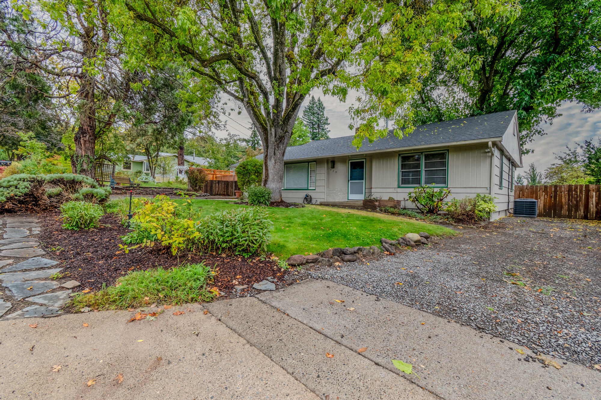 Opportunity awaits in one of East Medford's most desirable neighborhoods! This hidden gem sits on a spacious .21-acre lot with RV parking and is truly move-in ready. Inside, you'll find fresh interior paint, warm hardwood floors, beautiful kitchen cabinetry, and a comfortable split floor plan anchored by a cozy pellet stove. The primary suite offers private patio access—perfect for morning coffee or quiet evenings. The large backyard features a deck for outdoor entertaining, raised garden beds, and an outbuilding with electricity, ideal for a home office, art studio, hobby space, gardening, gaming, or play. With a new HVAC system in 2025, refreshed interiors, and convenient proximity to shopping, dining, medical facilities, and outdoor recreation, this home blends comfort, charm, and location perfectly.