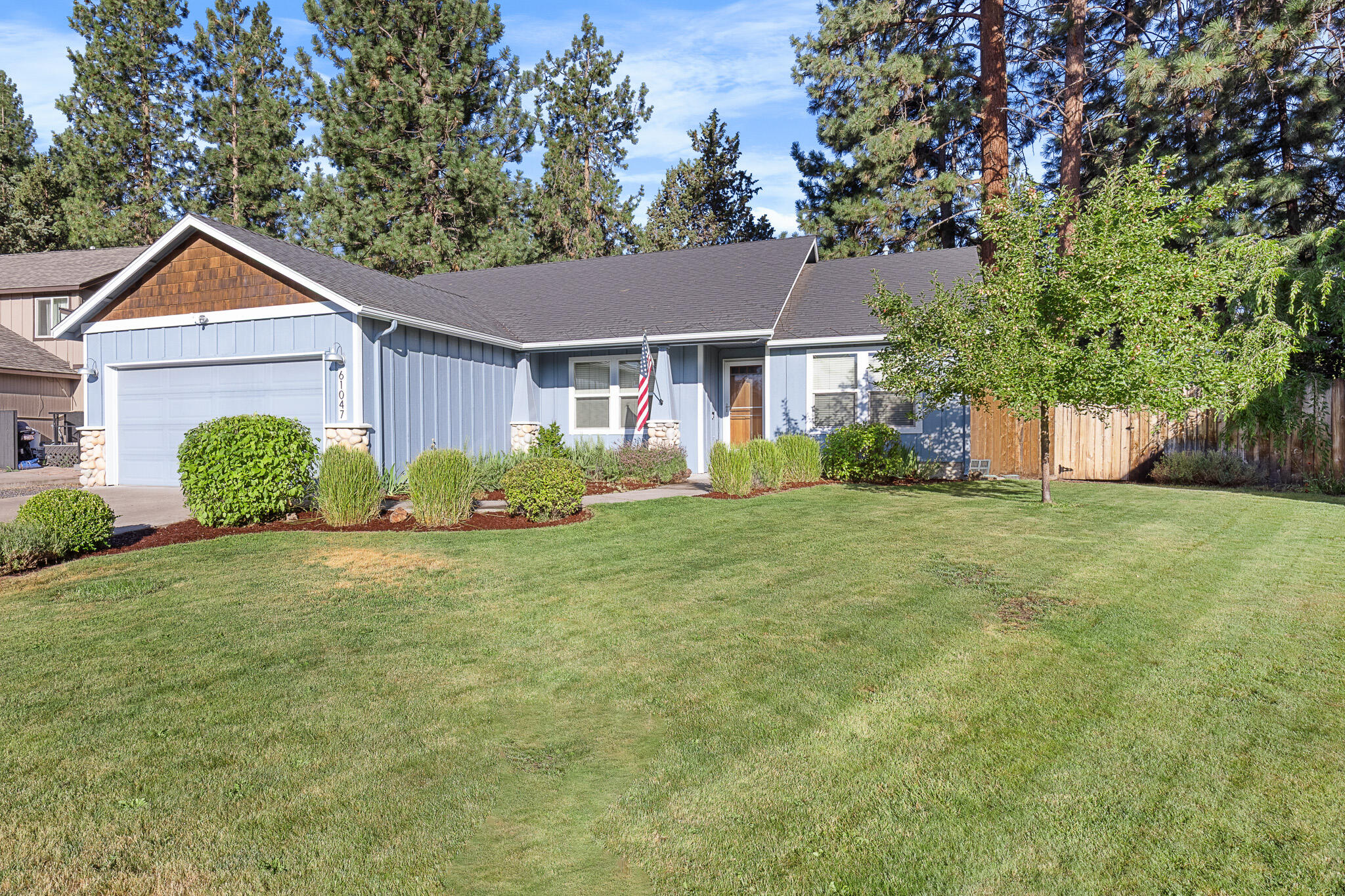 Immaculate Single-Level in the Heart of Bend on an expansive 1/3 -acre with RV parking. This beautifully maintained 3-bedroom, 2-bath home offers effortless single-level living.  A welcoming covered front porch opens to a sun-filled open floor plan featuring a vaulted great room with a cozy gas fireplace. The updated kitchen boasts granite counters, stainless steel appliances, and both a dining room and breakfast nook for flexible dining options. NEW: flooring, interior paint, recessed lighting, stylish fixtures, and ceiling fans add a modern touch throughout.
Step outside and embrace Bend's outdoor lifestyle in your private backyard retreat, 720 sq. ft. no-maintenance deck overlooking a lush, fully fenced yard with majestic ponderosa pines. Ideal for entertaining, summer BBQs, or peaceful mornings with coffee. Plenty of space for all your Bend adventures and easy access for toys and gear with Shop and oversized garage with EV 220 outlet. Pride of ownership shines in every detail.