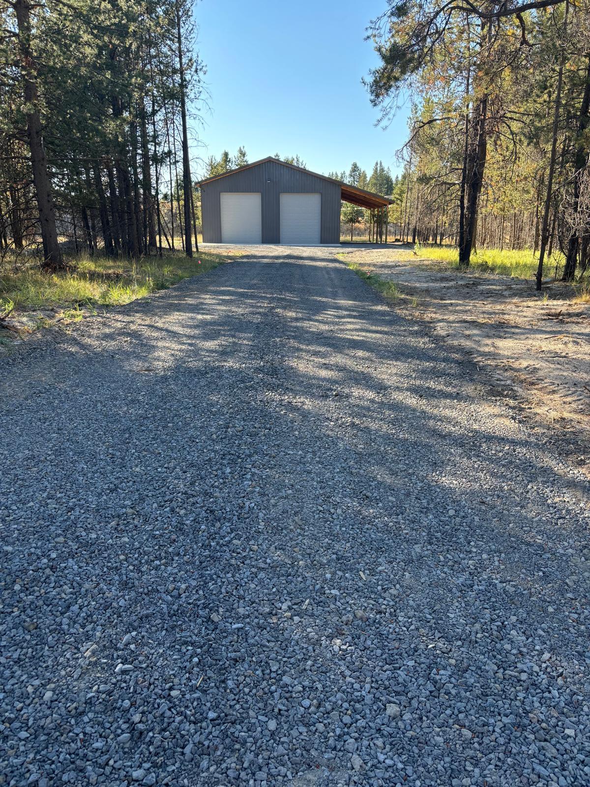 Discover an incredible opportunity to own a large shop on a spacious 2.54-acre lot. This brand-new 2,000 sq ft pole barn (48x40) with an additional 15x40 lean-to offers unmatched space and versatility. Ideally located on Lazy River and S. Century Roads, it provides quick access to all the best Central Oregon has to offer, from outdoor recreation to convenient amenities. The entire lot is enclosed with a post-and-rail fence with wire mesh and a gated entry, ensuring complete privacy and security. The shop features two large insulated electric doors, a full 200-amp power supply, a 30-amp RV hookup, and full interior lighting. A gravel driveway with a concrete apron adds to the convenience, making this property truly turnkey. Whether you need space for RVs, boats, ATVs, snowmobiles, tools, or equipment, this shop is the perfect solution. More than just storage, it's an ideal basecamp for outdoor enthusiasts eager to explore Oregon's endless adventures. Don't miss out, view it now.