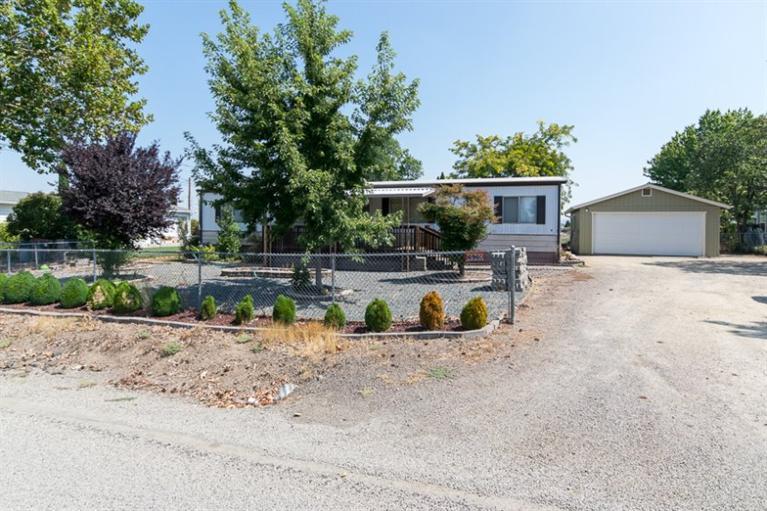 This is a wonderful opportunity for someone wanting RV parking with a well and on city services. This .33 of an acre has views of the Table Rocks in Central Point. There is a detached garage/shop already on the property with a nice yard. The 1979 double wide manufactured home needs some updating, but features a split floor plan, heat pump, forced air and a wood stove to make for a cozy winter. An electric stove and dishwasher, microwave, and gas hot water heater are also come amenities. Manufactured home has been moved twice. Cash or VA loan accepted only. Property is sold as is.