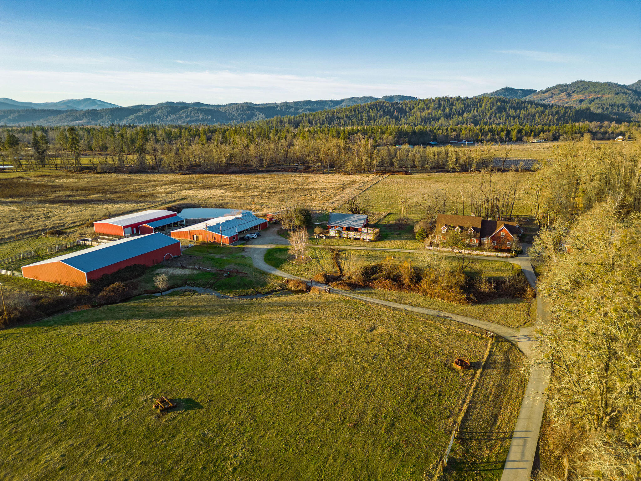 Working cattle ranch. 142 acre, multifamily ranch. Full water rights from Sucker Creek. Gated with a quarter mile long concrete driveway. Property has everything needed for any ranch wants. 3 concrete barns totaling over 32,000 sq. ft., 5 stall equipment bay, as well as a repair shop. Some of the oldest water rights in the area, it was originally homesteaded by the Holland family, and has a high end irrigation system throughout the property. Custom built house is over 6000 sq. ft., 2 car garage. A newer roof, HVAC system. 5 large bedrooms, 3.5 baths. Primary suite has 2 walk in closets. Living room has a beautiful rock fireplace that stretches from the floor to the ceiling, also a game room and office. House sits off of the road and is extremely peaceful and quiet. Other house is 1372 sq. ft. and was remodeled in 2010. Has 110/40 hay barn, a 4 stall horse barn with a heated office, oversized 2 car garage/shop, a fenced garden and a chicken coop.