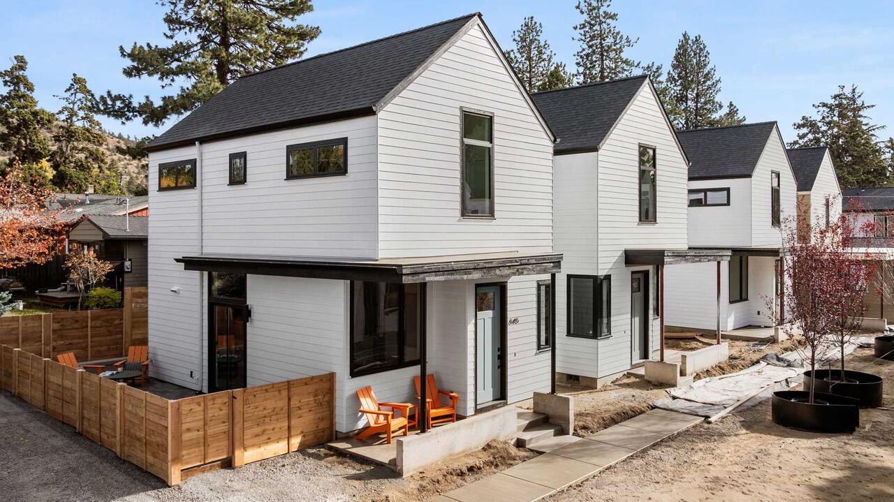Experience the best of Bend living at The Marshall Cottages, a new collection of eight modern homes located in the heart of vibrant Midtown. This light-filled, 936-square-foot Orchard  lan is designed for comfort and style, offering 2 bedrooms and 1.5 baths in a warm and inviting atmosphere. Step inside and feel immediately at ease with a spacious, open-concept living area, with 9-foot ceilings and large windows. The private, enclosed paver patio is a peaceful retreat, while the central courtyard offers a perfect place to gather with neighbors. This thoughtfully designed cottage includes ductless mini-splits for efficient heating and cooling, quartz countertops, luxury vinyl plank flooring, and a detached single-car garage. Move-in ready with all appliances included.  This home is your perfect low-maintenance ''basecamp for adventure,'' located just a short stroll from downtown, the Midtown Yacht Club, and Juniper Swim & Fitness Center.