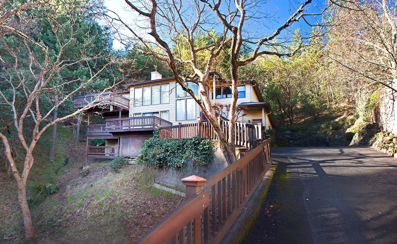 This wonderfully comfortable mountain nest combines views, light and privacywith nature on all sides. It's close to Ashland's best hiking and biking trails and just minutes to Lithia Park. The home's main level has a living room with fireplace, dining room, kitchen with eat-in area, half bathroom and spacious master suite with luxury bath, shower, walk-in closet-all surrounded by decks and views. The lower level has a family room, two more bedrooms with a full bath and deck, laundry room and two-car attached garage with workshop space. All is well-maintained including a new heat pump in 2008, newer roof and irrigation system with regulator. Outside are multiple view decks, a rear terrace and even a private picnic gazebo. Serenity awaits you.
