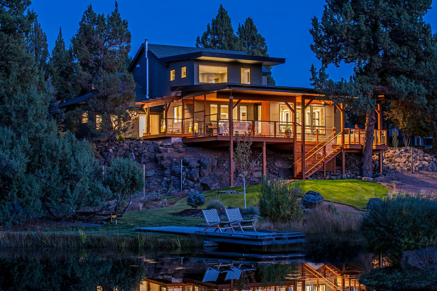 This beautiful, high-end custom remodeled, NW Contemporary style home sits on just over 10 acres in SE Bend. Backing to COI and Park & Rec lands, privacy, serenity and views abound. With 1100 sq ft of covered decking overlooking the landscaped pond this home is an entertainers dream. Open concept living, vaulted ceilings, heated tile and hardwood floors this 3667 sq ft home has it all. Large kitchen with Jenn-Air appliances, custom teak cabinets, 5'x10' island, granite counter tops and walk-in pantry. Office, guest room and large bedroom with private deck on main floor. 2nd level master has attached gym and opens to a secluded meditation/reading space and art gallery. Master bath has walk-in shower, soaking tub, heated towel rack and custom vanities with quartz counter tops. Large walk-in closet with built-in's throughout. Attached 2 car garage, 3 car garage/shop, RV parking w/30amp rec,10'x16'' finished outbuilding, 320 sq ft insulated greenhouse w/2400 sq ft adjoining garden area.