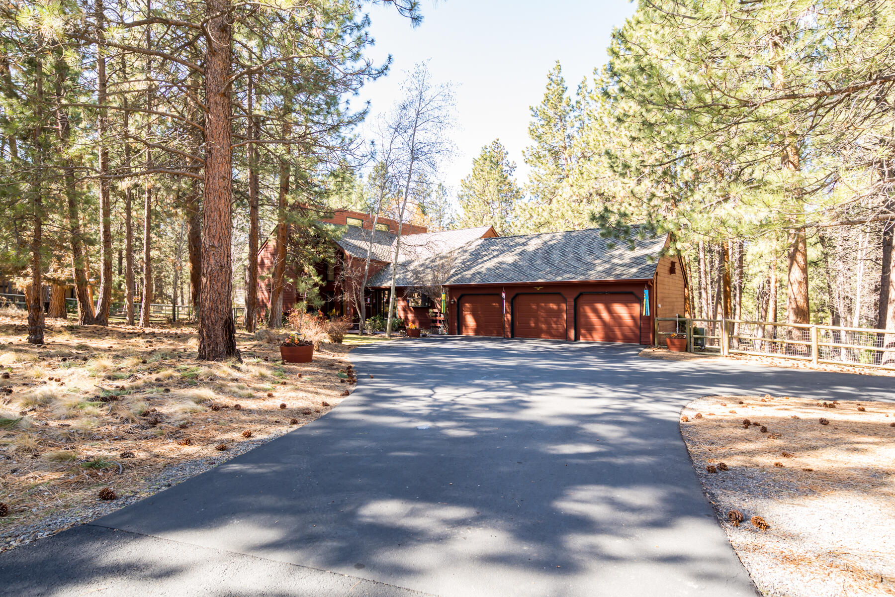 Quite possibly the nicest location and setting in Woodside Ranch. Original owners, custom built home on a 2-acre parcel. Hard to find 20'x 40' RV garage w/14' overhead door, Hardie Plank siding, 220 outlet. Great room, family & formal dining overlook the back yard w/access to the deck. Hardwood floor entryway, 2 pellet stoves, vaulted ceiling, skylights, wood framed windows & doors. Center island kitchen, oak cabinets, garden window, tile counters, slate tile flooring, pantry, breakfast bar and nook. Huge main level primary suite, slate flooring, dual vanity, tile counters, walk in closet. Upstairs features a loft area, 3 BR's, full bath w/dual vanity, walk-in tile shower. Fabulous water feature with a stream & pond, native plants, old growth Ponderosa trees, rock outcroppings. Professionally landscaped, fully fenced, gorgeous back yard, sprawling lawns, large back deck with arbor for entertaining. Attached 3 car garage, cedar sided, lifetime warranty roof and timber tech front deck.