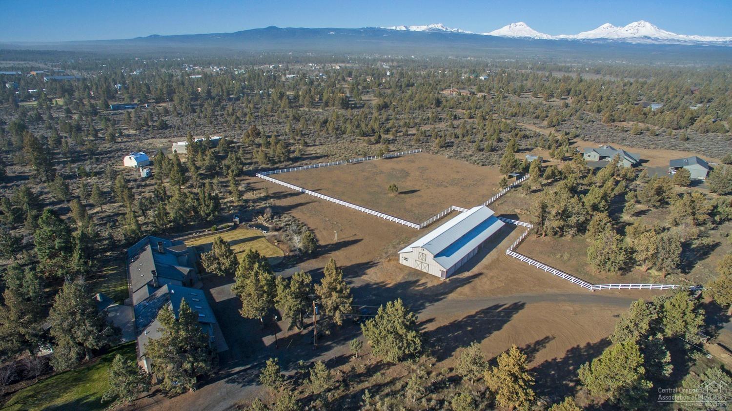 Exceptional Cascade Mountain views in a secluded landscaped setting! Top-notch horse property on 9.51 acres with gorgeous 7-Stall 2,640 SF barn, 2 fenced pastures & access to BLM. The beautiful single-level home has 3,708 total SF, including 3 bedrooms, 3 baths, family room or 2nd living area, kitchenette, 2 utility rooms & office, plus 2 upstairs hobby/bonus rooms accessed through the garage. Gourmet kitchen with island, walk-in pantry & outdoor pizza oven. Master on the main level has a fireplace, sauna, jetted tub, walk-in closet, 2 patios & outdoor hot tub. Barn includes wash stall, office/tack room & turnout area. 29X39-ft. 2-bay heated garage/shop has windows, 2 workbenches & storage cabinets. Additional single-bay garage with loft. Also: RV parking & hook-ups, workshop & a potting shed. Centrally located between Bend, Sisters & Redmond in the esteemed Sisters School District. 30 minutes to Redmond Airport. Enjoy world-class skiing & outdoor activities!