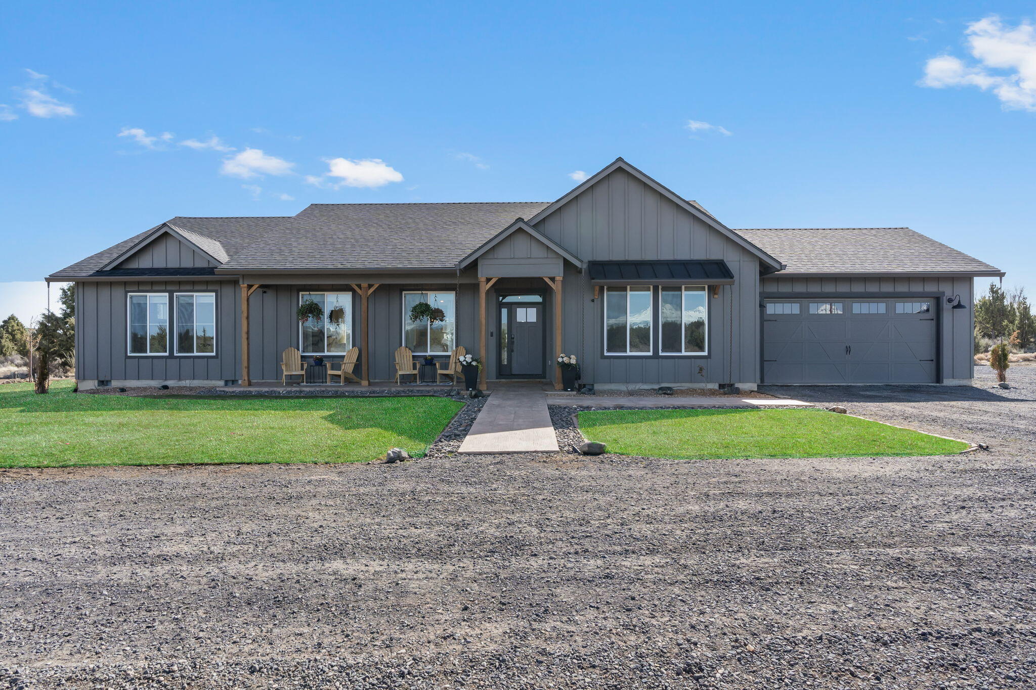 Situated on over 10 acres, this exquisite home, built in 2022, seamlessly combines modern luxury with unparalleled comfort. With sweeping mountain views and a thoughtfully designed split floor plan, this residence offers both elegance and functionality. Step inside to discover state-of-the-art features, including a built-in media hub, integrated surround sound systems throughout both the interior and exterior, and sophisticated LED lighting. The expansive primary suite is an exclusive retreat, with panoramic mountain vistas right from your bedroom window. The kitchen is a true masterpiece, showcasing high-end quartz countertops, a large island, a spacious pantry with a charming sliding barn door, and a stylish coffee/wine bar. The impressive 3,200 sq ft shop is a standout feature, complete with oversized garage doors and two vehicle lifts. Outside, the backyard becomes a sanctuary with a hot tub, stamped concrete patio, and a gazebo, creating the ultimate space to relax or entertain.