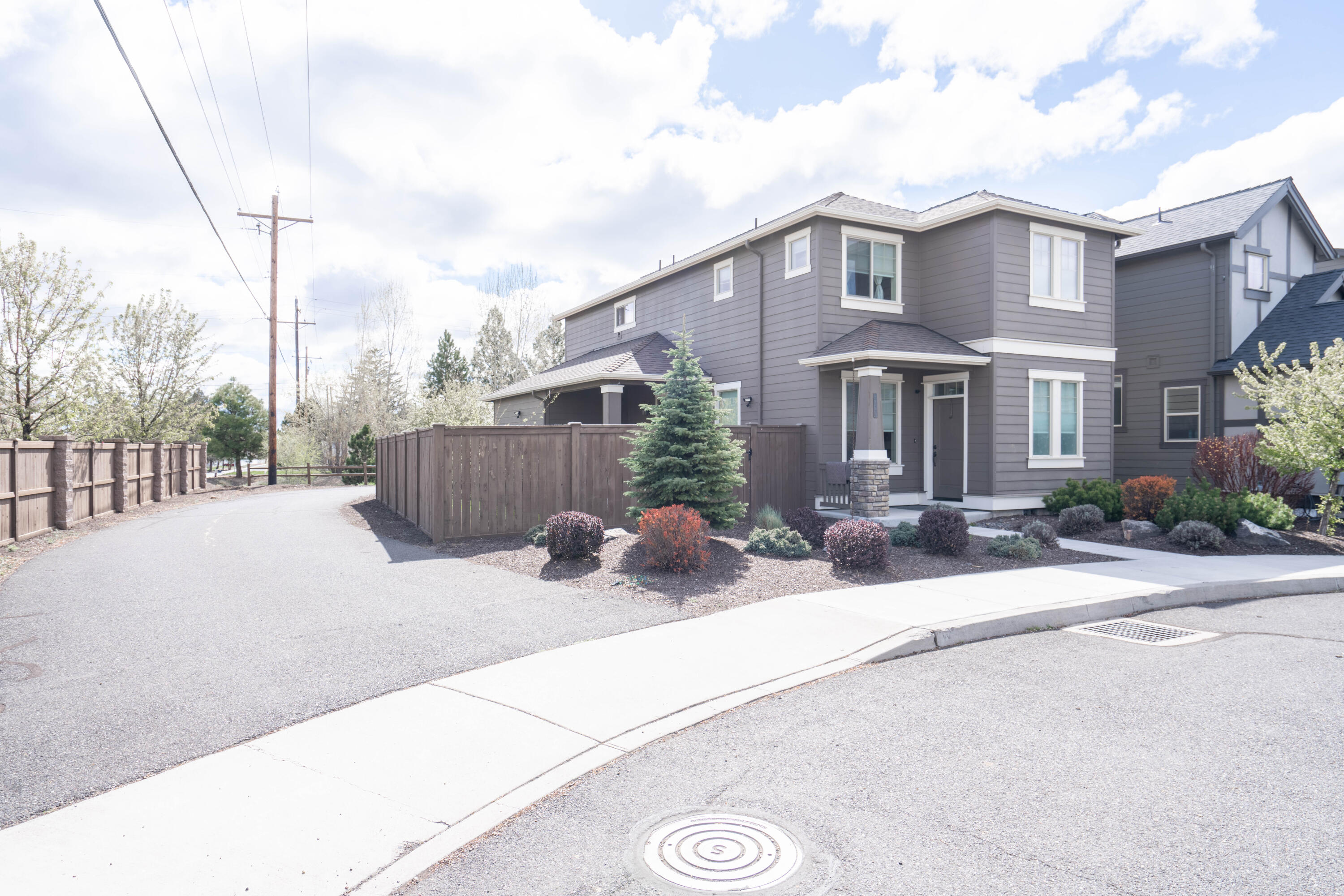 Great location in this end unit on a cul-de-sac that provides more privacy as well as landscaped and fenced backyard space. Quality-built Pahlisch home with numerous upgrades including stainless appliances, hickory cabinets, quartz counters with undermount sinks and LVP flooring plus updated lighting and new carpet on the stairs and in upstairs bedrooms. Additional features include ceiling fans, a covered porch, gas fireplace, an upstairs landing area as well as a walk-in closet and dual vanity in the primary bedroom suite. The oversized garage has a 3' extension for longer cars and trucks plus an additional storage bay ideal for recreational toys. Fantastic location close to schools, shopping and a golf course as well as convenient for Bend commuters with easy access to Highway 97. Not a drive-by - must-see inside this home! QUALIFYING 3.75 ASSUMABLE  MORTGAGE CALL OR TEXT FOR DETAILS