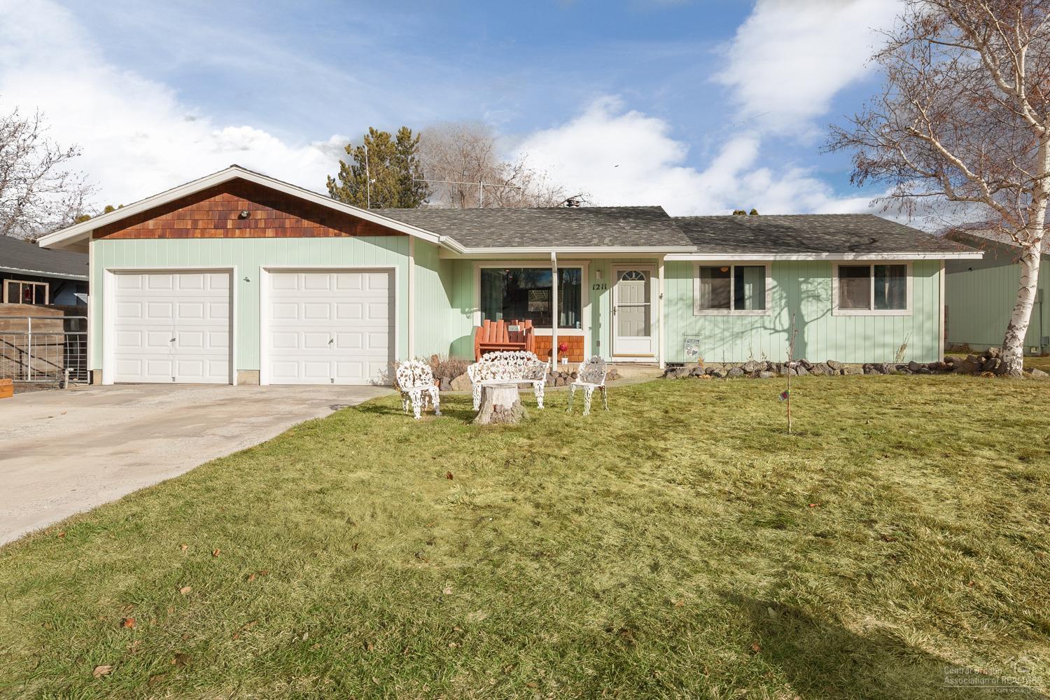 This spacious home has everything you need! 3bd/2ba w/open floor plan, vaulted ceiling, bar/island in the kitchen gives you plenty of room for entertaining. Wood fireplace will keep you warm the rest of the season. Fully finished garage w/2 automatic doors. RV parking and large gravel area in back provides plenty of space for toys! Storage shed in backyard, landscaped with fruit trees, grapevines, raspberry bush and much more! Relax on the covered porch in the hot tub! Must see home!