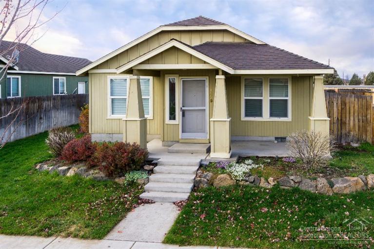 Cottage style home with alley access to garage. Tile entryway, tile back splash in the kitchen & baths. Covered front porch & patio with pillars. Fenced side yard with concrete patio.
