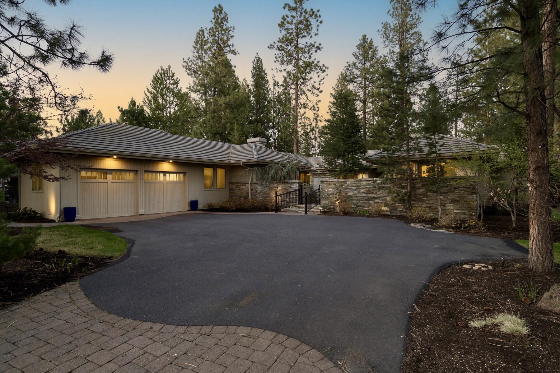Privately tucked among the pines overlooking the Broken Top Club golf course, sits this coveted single level custom home that seamlessly blends warm ambiance and luxury. Beyond the secluded front courtyard gates, natural light invites you into the open great room anchored by a stunning stone fireplace. Timeless quality finishes are coupled with numerous recent updates throughout. The ideal floor plan has separation of the primary suite and adjoining office with fairway views from the guest wing that includes a second ensuite bedroom plus third bedroom with fireplace and built-ins adjacent to a third full bathroom. The grand kitchen equipped with new professional appliances and Butler's pantry and the expansive covered rear deck overlooking the trees and course lend to easy entertaining and indoor/outdoor living. This desirable location in the westside of Bend provides convenient access to outdoor recreation, shops, dining and top rated schools. A perfect base camp for your lifestyle!