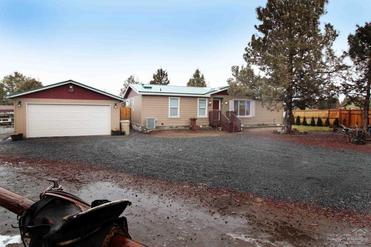 Price Reduced - This updated 3 bedroom 2 bath home lives LARGE. It boasts all brand new flooring in the living room, dining and hall. This turn key home is one to see. New energy efficient heat pump, new ext. paint on long lasting cement board siding. Guest bath has new tile floor, skylight, vanity and light fixture. The kitchen shines with all new stainless steel appliances, while the skylight adds an abundance of natural light. The master has large walk in shower and closet and is separate from the other bedrooms. There's also a new metal roof on the house and the double garage. This large 1.43 acre lot is fenced and xfenced. Currently set up for horses or create a masterpiece garden. Open riding just minutes away. An insulated 10x20 tack room (negotiable) makes life easy. 2 paddocks, a 12x20 hay shed, 16 ft gate will assure your animals & kiddos are safe at all times. Community pool, park, tennis, restaurant/bar and award winning golf course. Did I mention Mt.Jefferson views!