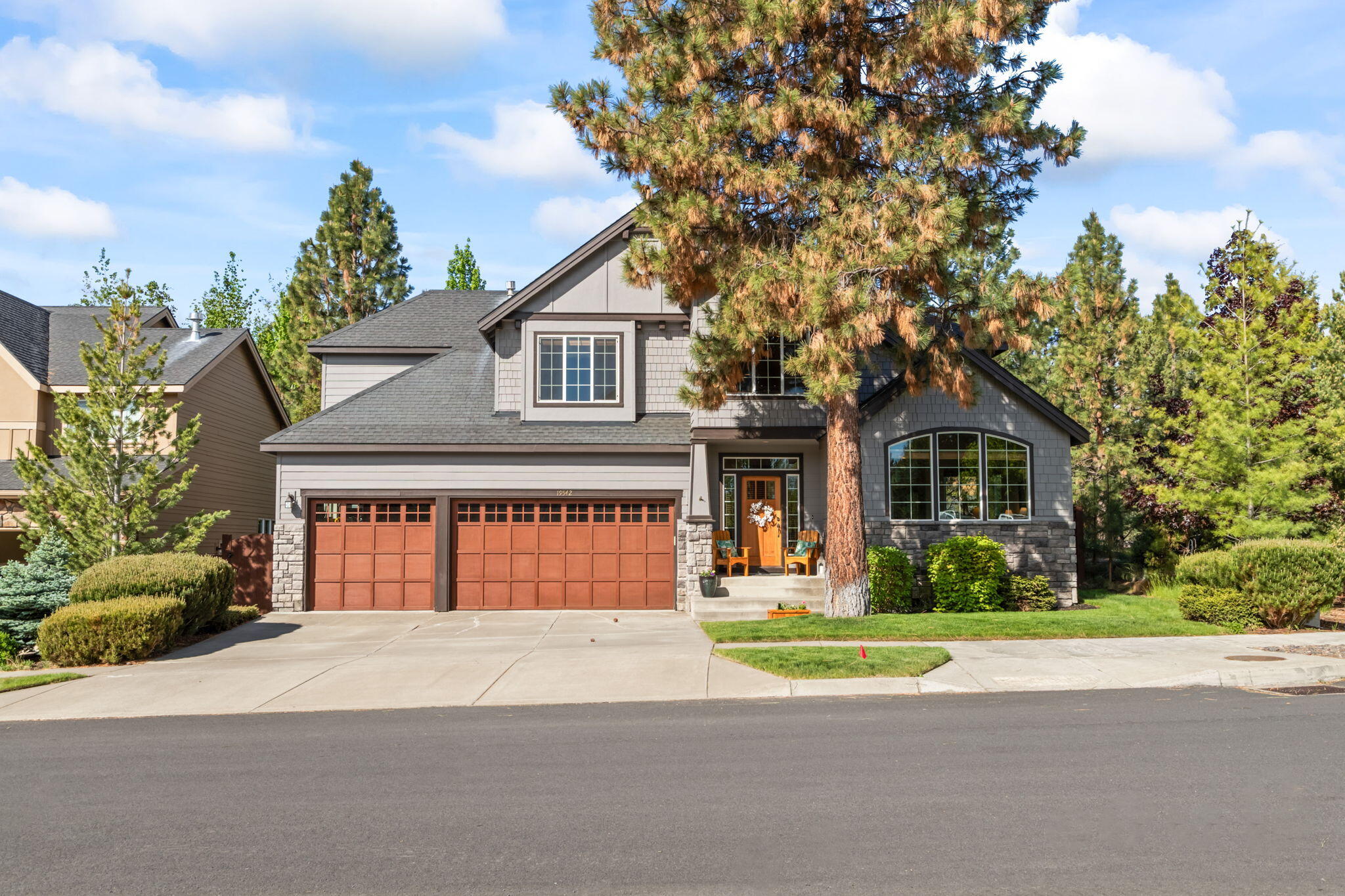 Discover this pristine home in one of Bend's premier neighborhoods, celebrated for its proximity to the Deschutes River trail, welcoming community, and excellent amenities. Enjoy the tranquil sounds of the river from this near-canyon rim location, just steps away from trail access. The bright, open foyer leads to a spacious, inviting floor plan. The expansive kitchen features ample pantry, cabinets, and counter space, seamlessly connecting to the great room with views of the meticulously landscaped, private backyard. Adjacent to the dining room, a secluded side patio offers an intimate seating area. Upstairs, the primary suite includes a walk-in closet, shower, soaking tub, and double vanity, complemented by two additional bedrooms, a bath, and a versatile bonus room. An open balcony provides additional light and is a perfect spot for an office or study. Ideal for outdoor enthusiasts, this home also includes a 3-car garage and convenient access to all that Central Oregon has to offer!