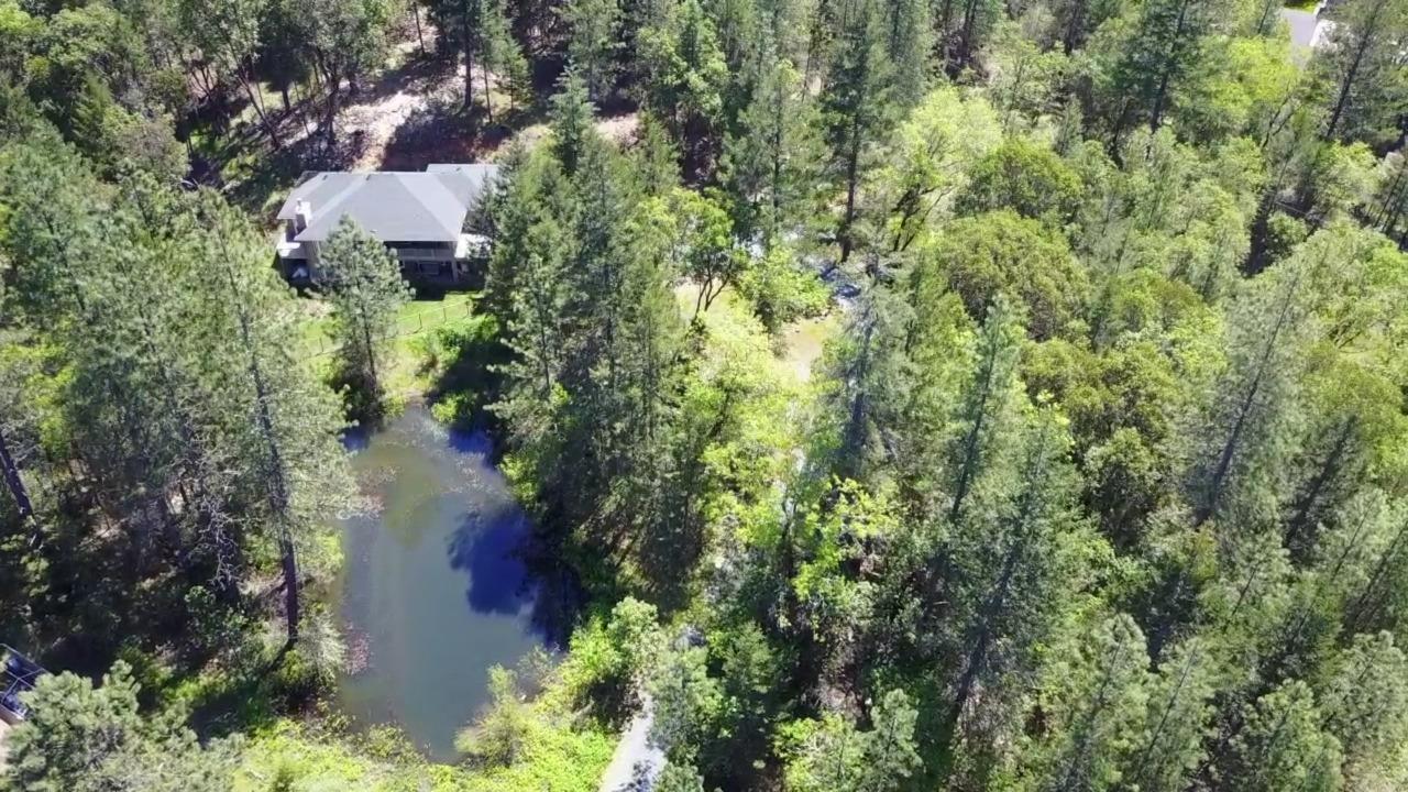 Built by homeowner and tucked away this beautiful custom built home with two ponds. All living area is on the main floor with master bedroom and bath, porch overlooking your private pond, living room, nice open kitchen with Granite and cultured marble window sills throughout and in showers. Oregon Marble Fireplace keeps you cozy along with Heat Pump. This home has additional living area below with two more bedrooms. Room for Pool table and desk area. Over-sized garage, private gate to property and did I mention two ponds? They are seasonal however main pond can be year round with diverter from the well to keep it full. Property has water filtration system, custom accents throughout and a very usable floor plan. Call to view. Virtual tour available. All information deemed accurate but not guaranteed and subject to change at any time. Buyer to perform all their own due diligence. Home Warranty through First American.