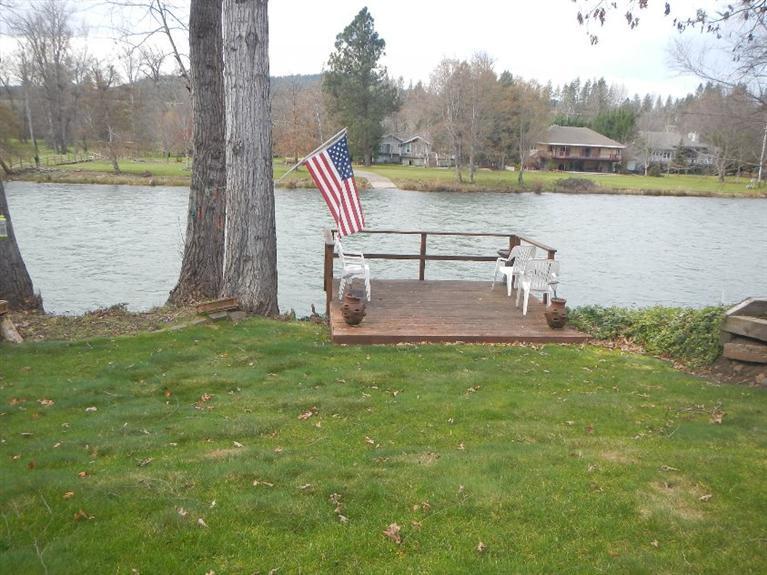 This Rogue Riverfront property has it all! Home sits close to the river for impressive views. There's a fishing dock and grass down to the Rogue. Gated entry, two car garage, two large sheds and a shop on this .61-acre property. The newer wrap around Trex decking is great for any large parties. The triple wide manufactured home is top of the line and has many upgrades. Open floor plan, country kitchen with island, upgraded cabinets and stainless appliances. Living/dining is oversized with river views and has a woodstove to warm those cool winter nights. The master bedroom is quite large and has a separate study within. Soaking tub, split sinks and separate shower. This master suite was designed for a king. Anyone searching for great Rogue frontage and a pristine home - this is it!