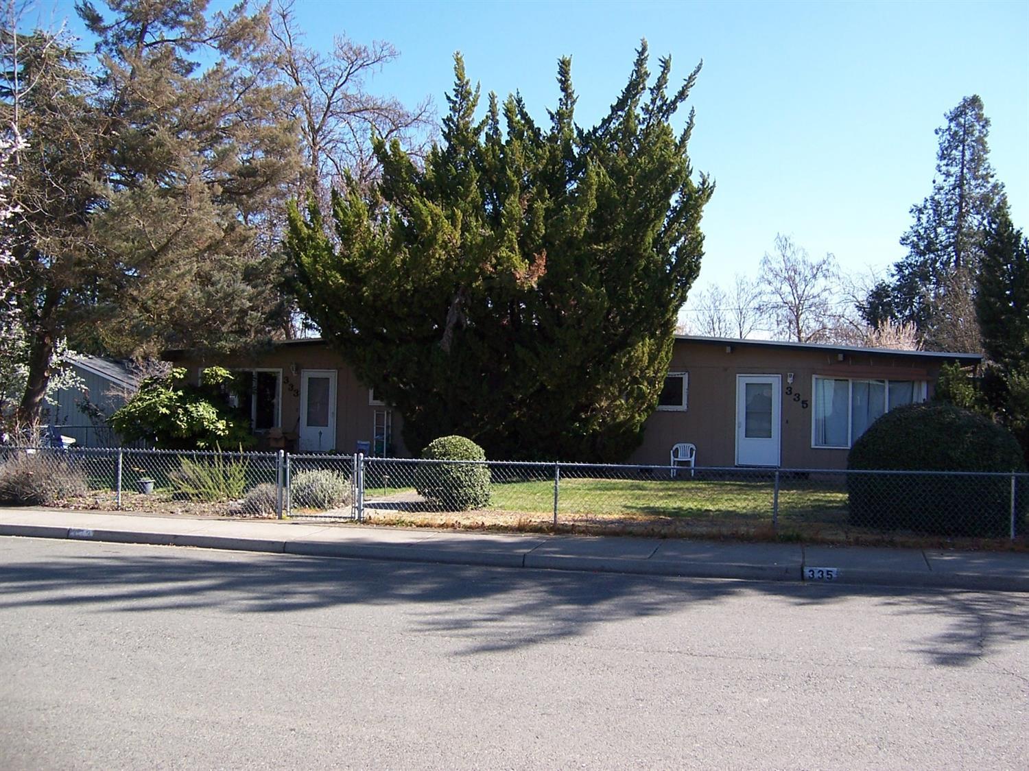 Great opportunity for Investors and/or Owner occupied Buyers. Nicely maintained Duplex in down town Medford. Both units are occupied and have been managed by the owner. Both of these units are approx. 1,024 sq.ft. each with huge living rooms, dining areas & massive bedrooms. #333 is a 2 bedroom/1.5 unit with 1-car detached garage. #335 is a 2 bedroom/1.0 bath units with a 1-car detached. Both units have very large bedrooms, vaulted T&G ceilings, lots of beautiful Hd-Wd floors & interior utility areas with W/D hook-ups. The oversize 2-Car garage is approx. 576 sq.ft. with an additional (16'x24') 384 sq.ft. shop area located at the rear of the garage. Both units have big front yards, large private rear yards with nice patios. This duplex is located on a large 0.23-acre corner lot with chain link fencing & mature trees. Both units have long term tenants and therefore the rents are well below market. Both units currently rented at $600.00/month. Water, sewer & trash included in the rent.