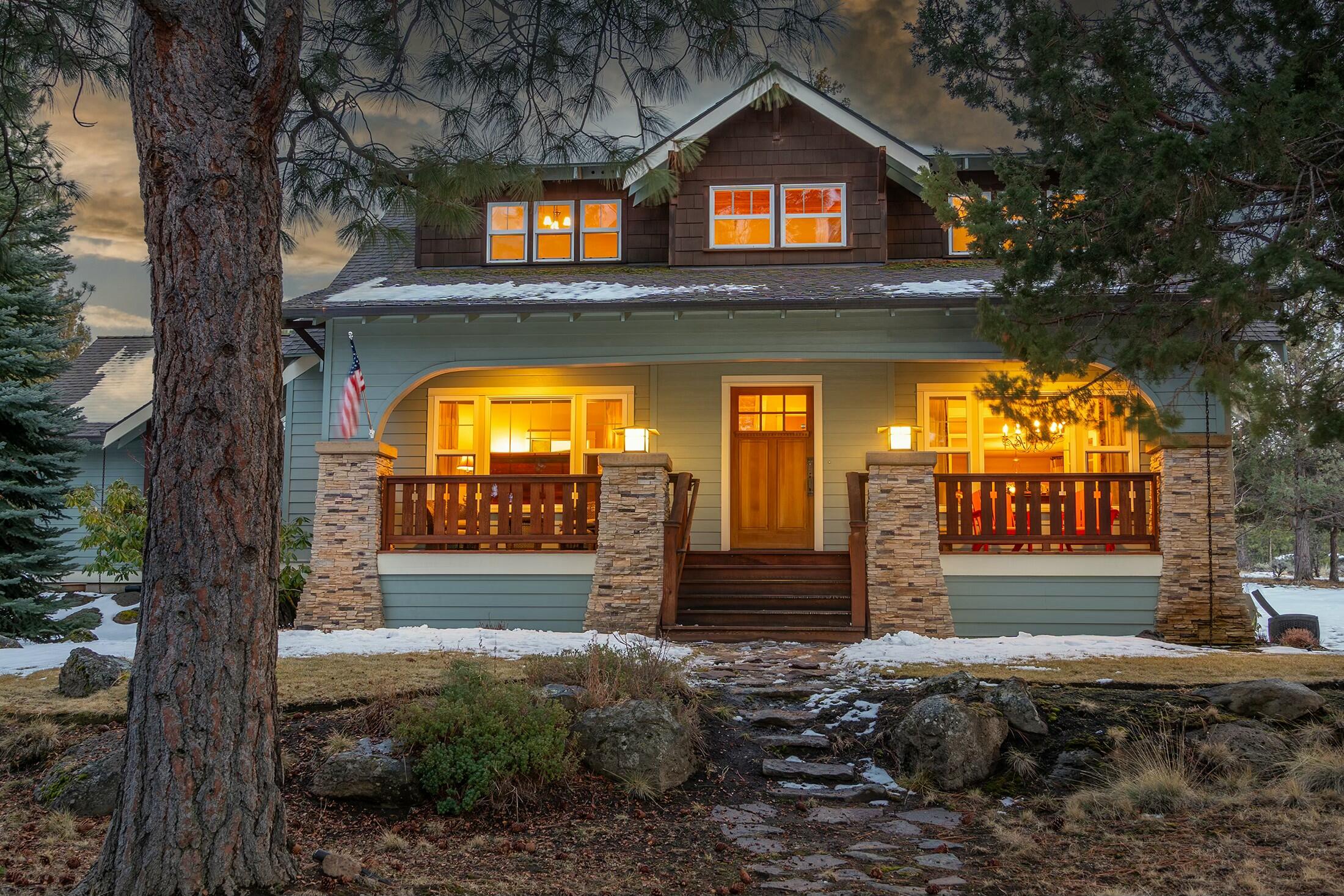 Nestled in the heart of Awbrey Butte, this exquisite Craftsman home offers timeless charm and modern comforts on a private corner 1.04-acre lot. Beautiful oak hardwood floors and quarter-sawn oak cabinetry enhance the warm and inviting interior, while the gourmet kitchen boasts granite countertops and Dacor oven & stove. The kitchen seamlessly opens to the spacious living room, where built-in cabinetry and a gas fireplace create a cozy and inviting atmosphere. The main-level primary suite serves as a serene retreat with its own gas fireplace, a luxurious soaking tub, and heated bathroom floors. Upstairs, you'll find three additional bedrooms and a generous bonus room, perfect for a media room, playroom, or home office. Enjoy outdoor living on the charming wraparound porch or unwind by the picturesque waterfall and pond. A rare 4-car tandem garage provides ample storage for all your needs.