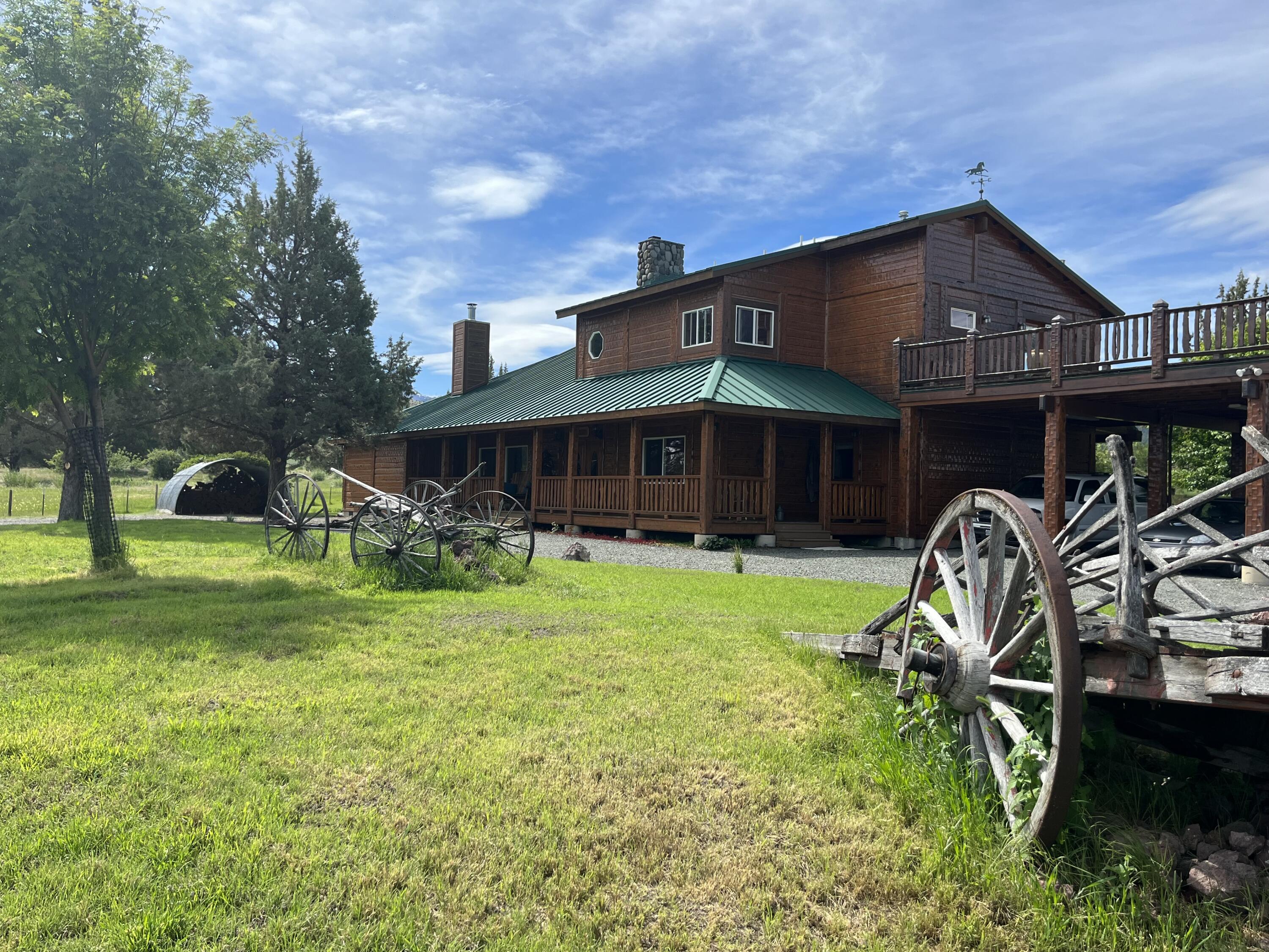 Absolutely stunning 3500+sq custom juniper log home situated on 50 acres in between John Day and Prairie City, OR.  3 bedrooms include a huge master bed/bath and 2 additional bedrooms. 
 High end kitchen with commercial refrigerator and an 8 burner propane stove in the center island located under an incredible copper hood.  Large pantry, a mini-bar, and an offset dining area make the home ideal for entertaining guests.  Covered porches, private patio and sun deck, custom waterfall and pond, huge yard and lawn with mature shade trees, garden area, dog kennels and numerous outbuildings.  Pine Creek runs through the property for over 1000' and pride in ownership abounds around every corner on this country property.  Immaculate 30 x 40 shop w/concrete floor and heat, 20 x 40 machine shed for equipment storage and a small, but nice horse barn with a saddling area and covered storage.  Outside the barn are cattle processing facilities and a small set of corrals.  Truly a must see.