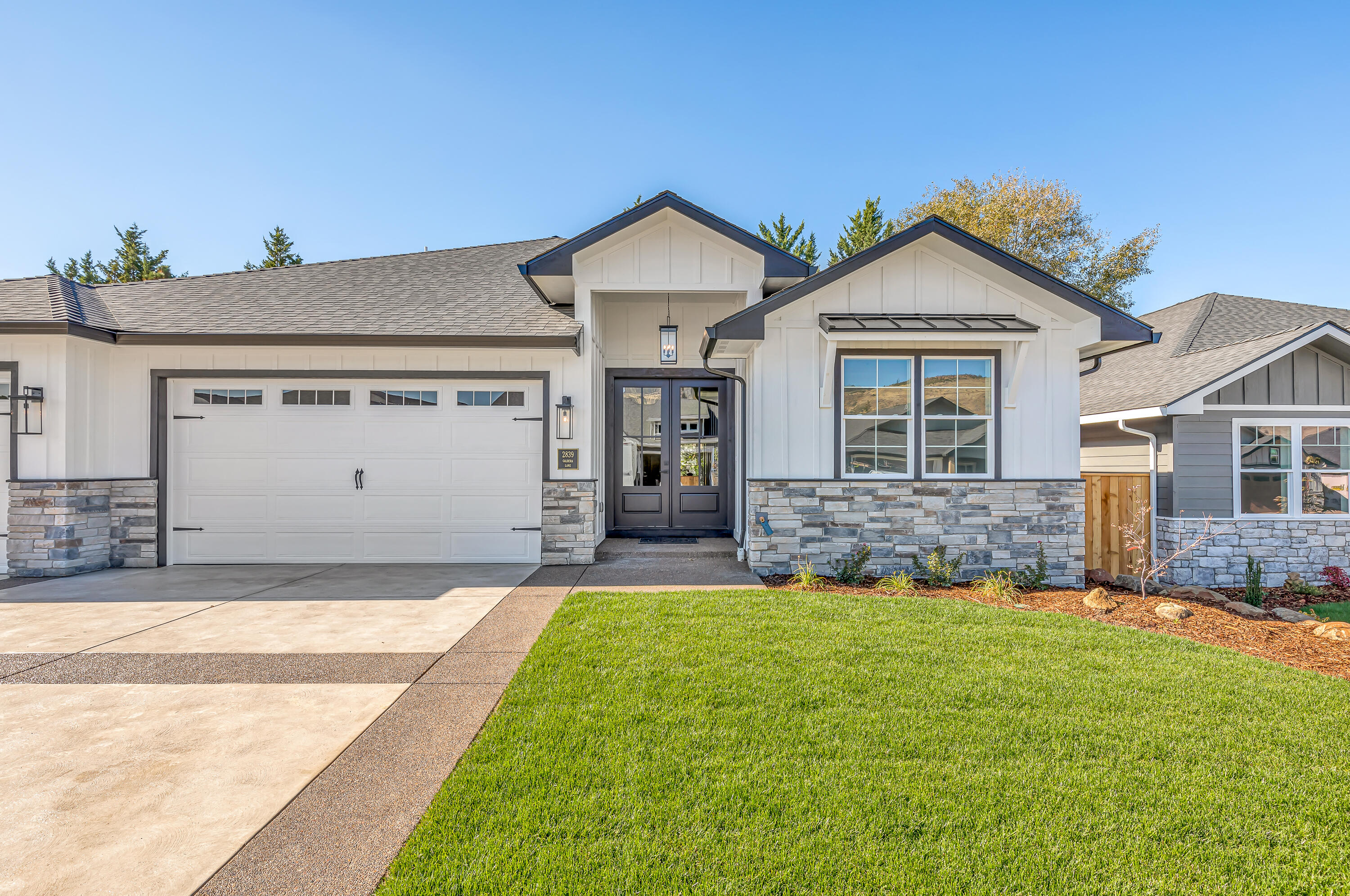 New Classic Farmhouse Style Home with 3  Bedroom's, 2.5 Baths and 3 Car Garage on .2 of an acre. The builder added so many high end and special features! 
.As you step thru the stunning double entry doors into the gorgeous entry hall you will feel the spaciousness of this over 2500sft ft home and see the attention to detail. High end fixtures, extra lighting, classic trim work and gorgeous ceiling beams!
When you enter into the great room you will see the huge island with custom cabinets, large farm house sink, gorgeous granite counter top and lots of room for seating. Beyond the island you will see the breathtaking Custom Hood, classic backsplash, oversized gas cooktop and oven. This Kitchen is a Chef/Entertainers delight.

The attention to detail in the Great Room is Breathtaking! 

The master bath has double sinks, stand alone soaking tub and stunning tile shower and tile floors. The master closet is large and perfectly designed.
Don't miss the  Mud/Laundry Room.