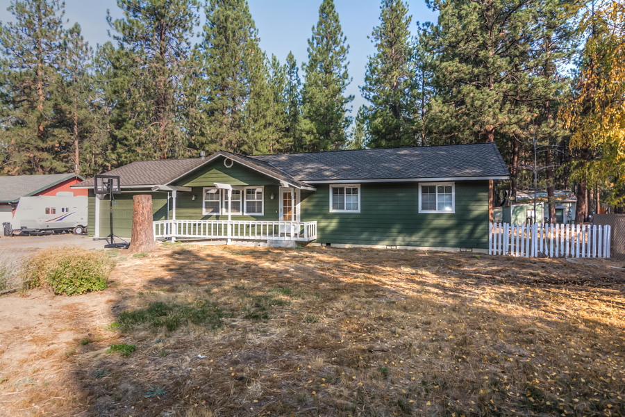 Deschutes River Woods is calling! 3 bd 2bath stick built home on .93 acres of privacy!  Nestled in the Pines this cute house has a long driveway with room for RV parking.  Full kitchen has newer butcher block counters, and includes all SS appliances. Newer 50 year roof, water heater, cadet heaters. Enter to beautiful bamboo flooring, and solar tubes for tons of natural light!  AC, ceiling fans in every bedroom. Front porch has ramp access, backyard has large patio with pergola, outbuildings, and room for a shop! Double attached garage with 220V. So much potential to be had.  Bring your own touches and make this great property your own today.
