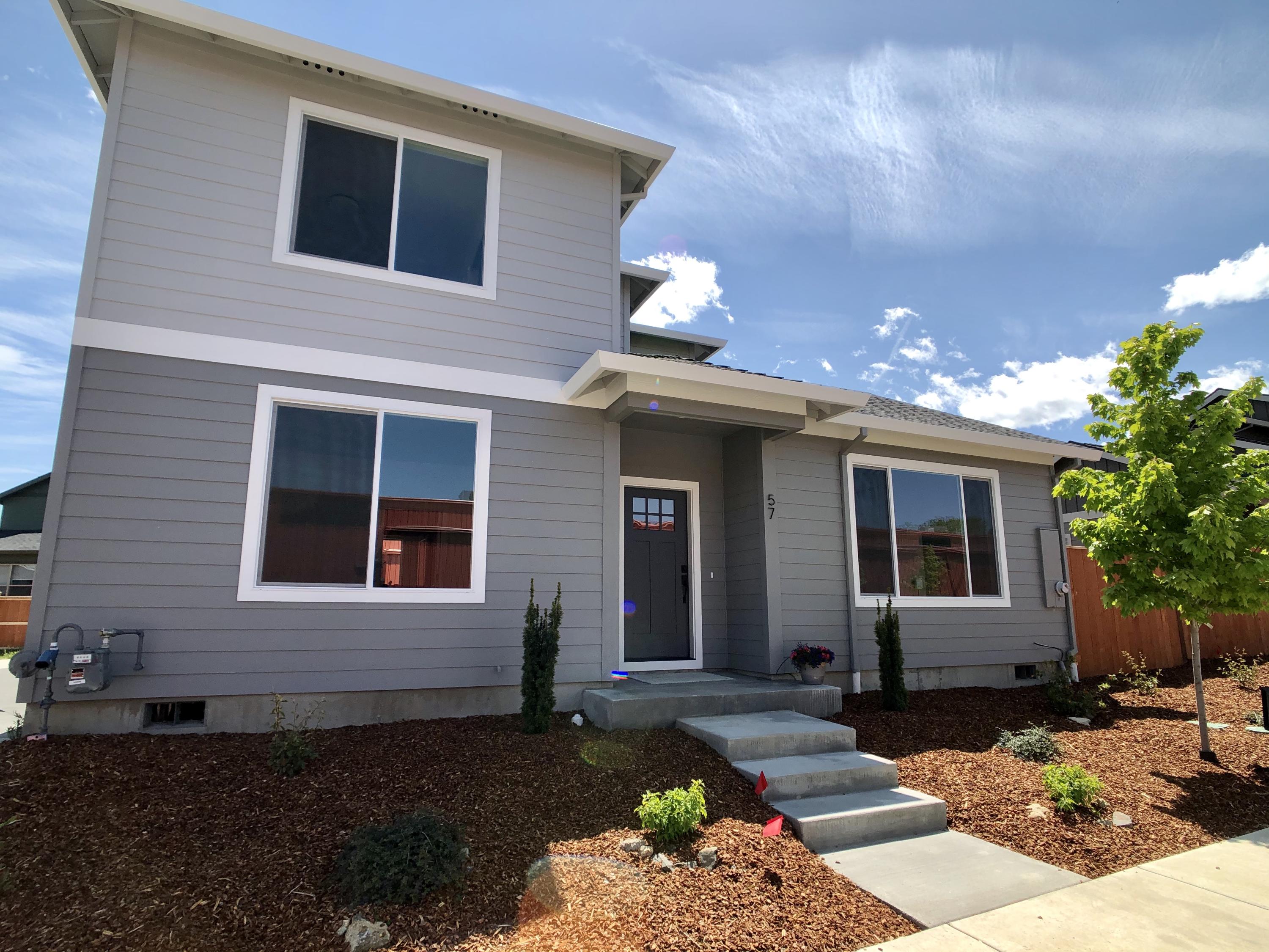 Complete and ready to move in now! This brand new Earth Advantage certified contemporary craftsman by Suncrest Homes has 3 bedrooms, 2 1/2 bathrooms, 1383 sqft, and attached garage. Quality amenities include quartz countertops, wood floors, tiled showers, tiled floors, Moen fixtures, and much more! In Talent's wonderful new neighborhood centrally located between the Rapp Road and Chuck Roberts Park, this brand new home is only a couple blocks from downtown Talent.
