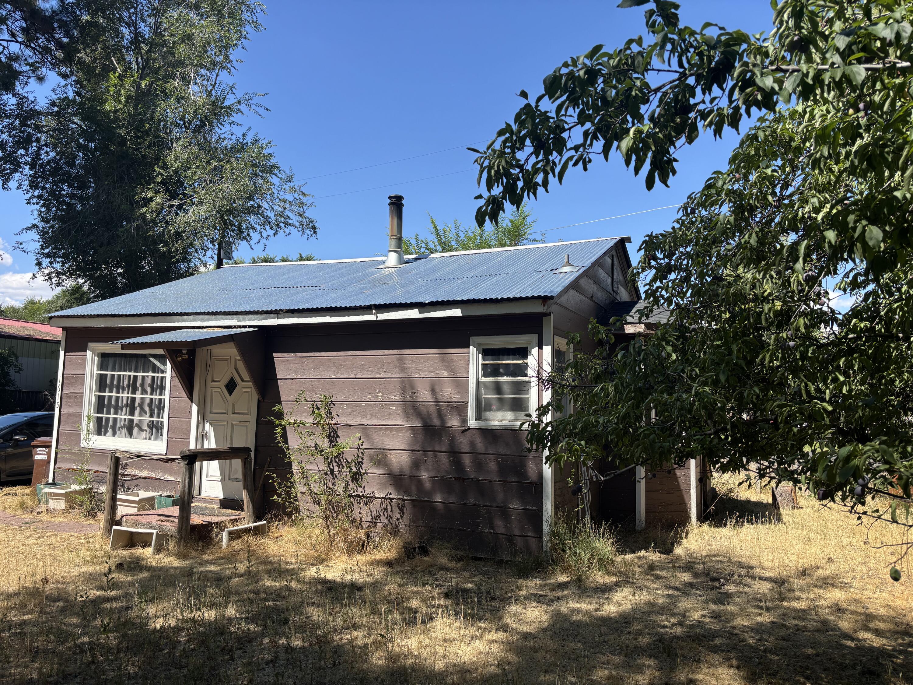 Thank you for viewing! Just imagine the possibilities with this bungalow home on a .19 acre lot zoned R2. The uses and options are wide and varied! Rent the home while you plan for the next highest and best use... this property is a short walk to wild ride brewing, Starbucks, numerous shops and restaurants with close proximity to downtown and the medical center plus an easy drive to two reservoirs! A great opportunity NOT in the flood plain, with a surprisingly nice floor plan and use of space inside. A newer well pump, detached single car garage and additional storage shed with partial fencing, a metal roof and true hardwood flooring are some of the benefits and surprises.