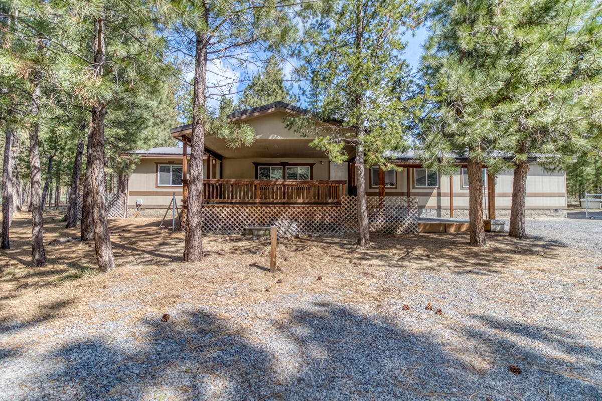 Welcome to your secluded, move-in-ready retreat in Ponderosa Pines! This charming 4-bedroom home is freshly updated with new carpet and paint, creating a clean canvas for your personal touch. The spacious layout includes a primary suite with a versatile bonus room and a split-bedroom floor plan for privacy. The large kitchen features an island and pantry with views of the peaceful, partially fenced backyard and forest. Outside, a massive 40 x 60 metal pole barn offers unlimited potential for your dream shop. The property boasts durable metal roofs on both structures, covered decks, and an Onan whole-house generator for year-round peace of mind. Located in a Fire Wise community, you get direct access to trails from your backyard and are just minutes from rivers, lakes, and mountains. Don't miss this opportunity for the perfect home!