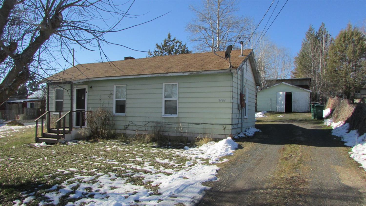 Don't miss this neat and tidy 2 bedroom, 1 bath cottage. 540 square foot unfinished garage, 192 square foot shed and a 24x36 shop with cement slab and 220 power. This is located close to town yet has a country feel.