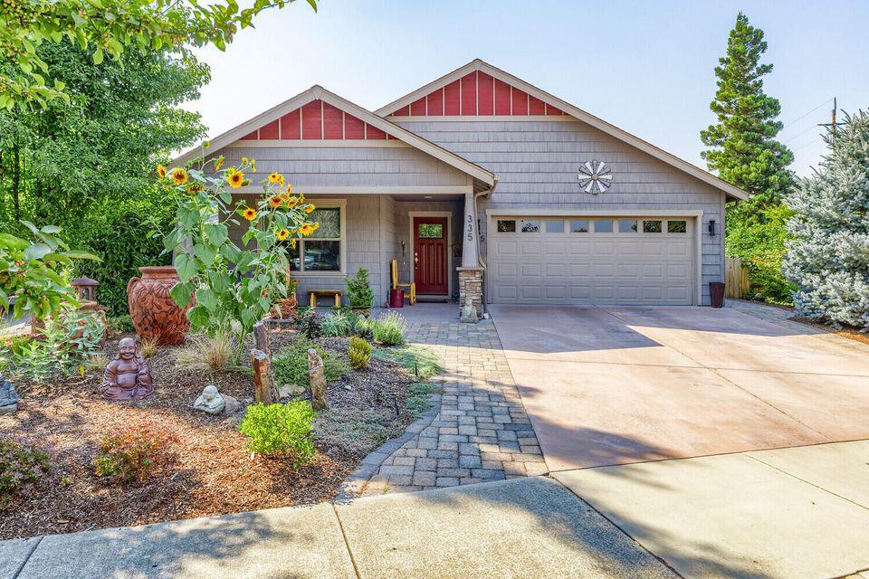 BEAUTIFUL INSIDE AND OUT!  This charming single-level Earth Advantage Certified home (built in 2012) blends modern comfort with lush outdoor living. Offering 3 bedrooms, 2 baths, and 1,752 sq. ft. on a landscaped 0.18-acre parcel, it features an open floor plan with hickory hardwood floors, stylish updated lighting, a ceiling fan, and a cozy gas fireplace. The kitchen is a delight with granite counters, upgraded appliances, a breakfast bar, and adjoining dining and living areas.
The inviting owner's suite includes an en-suite bath with a walk-in jetted soaking tub and separate shower. Step outside to a garden sanctuary—complete with a grape arbor lit by timed patio lights, a small lily pond with a waterfall, high raised garden beds, plum and cherry trees, raspberries, and thornless blackberries. Enjoy a covered gazebo draped in grapevines, a powered garden shed, and a professionally landscaped front yard.
Relax, unwind, and make this beautiful home your own oasis.