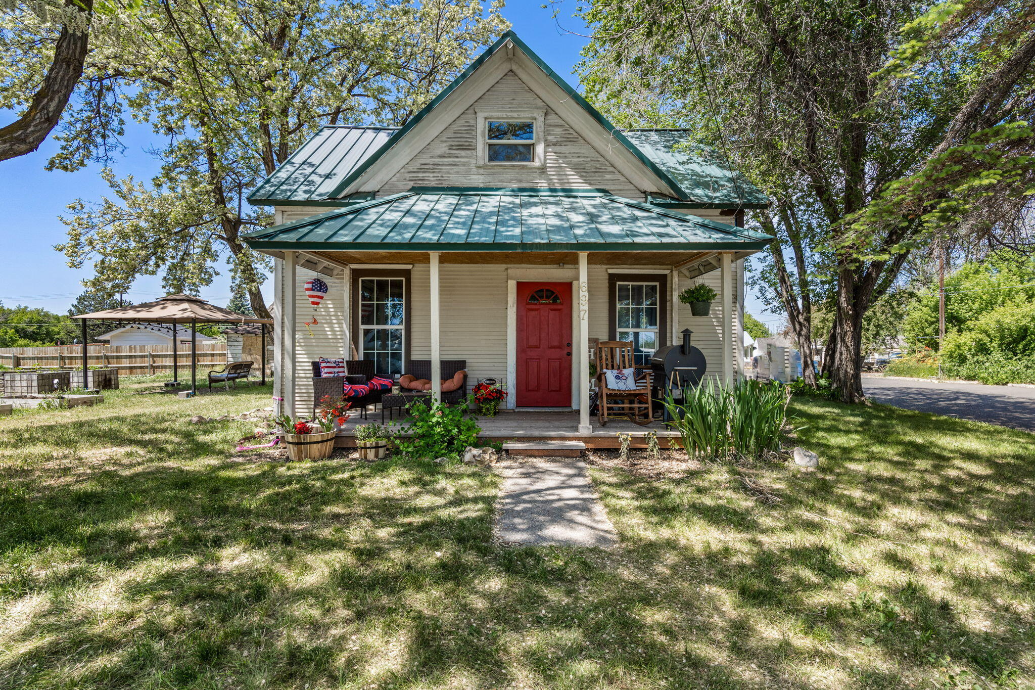 Quaint, Historic 1906 Charm in the heart of upcoming Prineville. Very large, corner lot with gorgeous old growth trees, adjacent to peaceful public greenway. Perfect investment opportunity or starter home. 3 bedrooms, with main bedroom on first floor. Large utility room and pantry off kitchen.  Double- pane windows and hardwood floors. Property being sold As-Is.