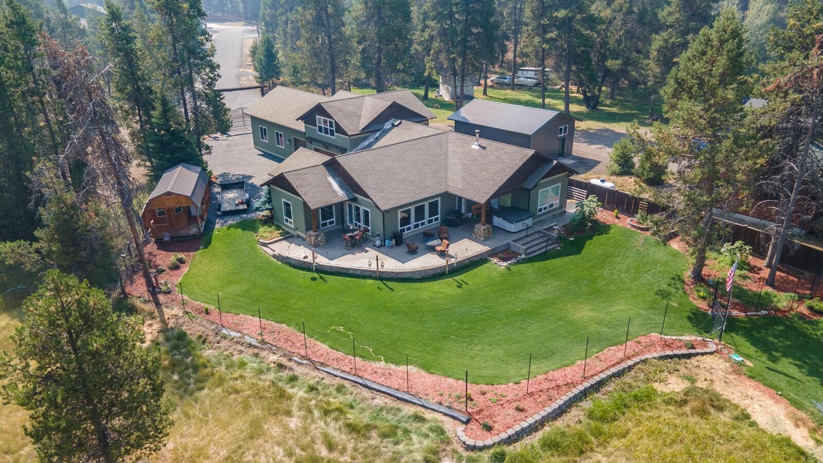 Welcome to your private Central Oregon retreat with breathtaking views and direct access to the Big Deschutes River. Just 30 minutes from Mt. Bachelor, this stunning custom-built home offers over 220 feet of river frontage and sits near 40 acres of US Forest land perfect for nature lovers and outdoor adventures alike. Tucked behind a gated log entrance on a fully fenced property, this home blends comfort, quality and craftsmanship. Inside you'll find vaulted ceilings, rich hickory floors, custom tile work, and an open-concept layout designed for gathering. The chef-inspired kitchen showcases a striking 16' curved granite island and handcrafted cabinetry for both beauty and function. Additional highlights include 25x40 attached shop, a 9x14 greenhouse, and an 8x20 floating dock for easy river enjoyment. Entertain or unwind on the expansive 16x45 paver patio, surrounded by peace, privacy and picturesque views. This is more than a home-it's a lifestyle.