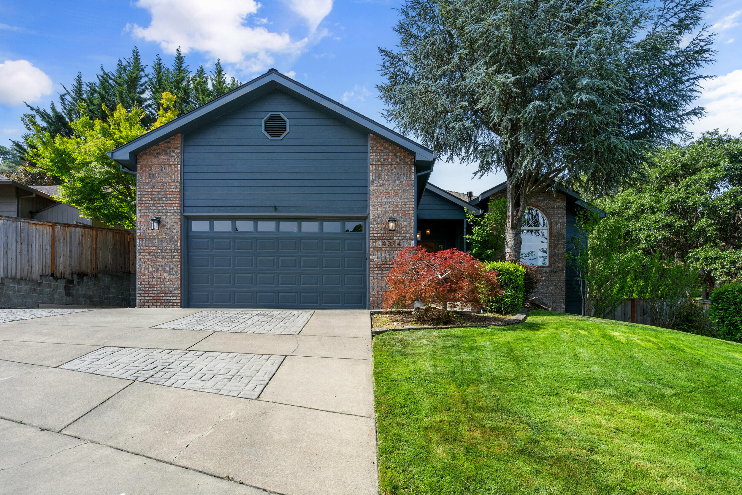 Back on Market, no fault of property. Charming East Medford Home with Exceptional Features! Nestled in a peaceful cul-de-sac, this beautifully landscaped 3-bedroom, 2-bathroom home offers the perfect blend of comfort and convenience. Step inside to a bright, open floor plan featuring a stunning remodeled kitchen with a huge pantry, large dining area, and modern finishes. Enjoy views of Roxy Ann from the spacious living room complete with a gas fireplace. The expansive primary suite offers a slider to the backyard, plus a luxurious primary bathroom with a large walk-in closet, double vanity, walk-in shower, and an oversized jetted tub for ultimate relaxation. A spacious laundry room with storage and a sink adds extra functionality. Outside, enjoy the large, covered patio, oversized 2-car garage, additional parking, and a workshop underneath the home.  This home is a must-see!