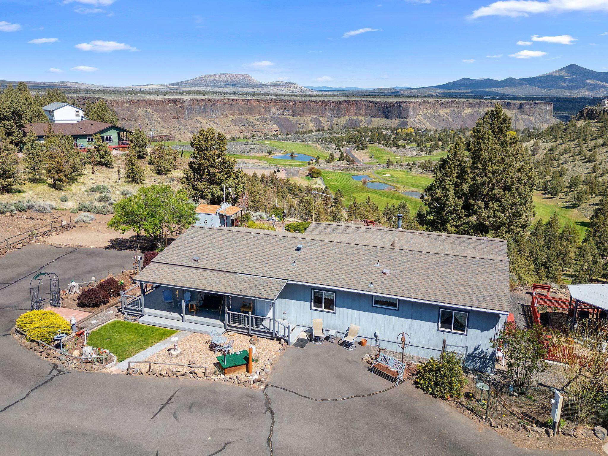 Breathtaking! The only word to describe the view from this one of a kind property. Sit in the living room picture window or sip your morning coffee on the deck or in the gazebo, looking over the rim of the Crooked River Ranch Canyon--view is unbelievable! Sprawling 3.53 acre property has it all: cozy well cared for 3 bed/2 bath home, 2 large decks, multiple outbuildings including garage, RV storage, large woodshop. Spectacular views from every window. In winter, use the heat pump or the rustic woodstove! Backyard landscaping provides a peaceful respite from everyday hustle and bustle. Horse trail just down the street! Take advantage of all Crooked River Ranch has to offer! Sale includes tvs and appliances.  Some furniture/woodshop equipment negotiable. It may be possible to split tax lots--buyer to do due diligence. This unique property will not last long! Come visit--you will fall in love!