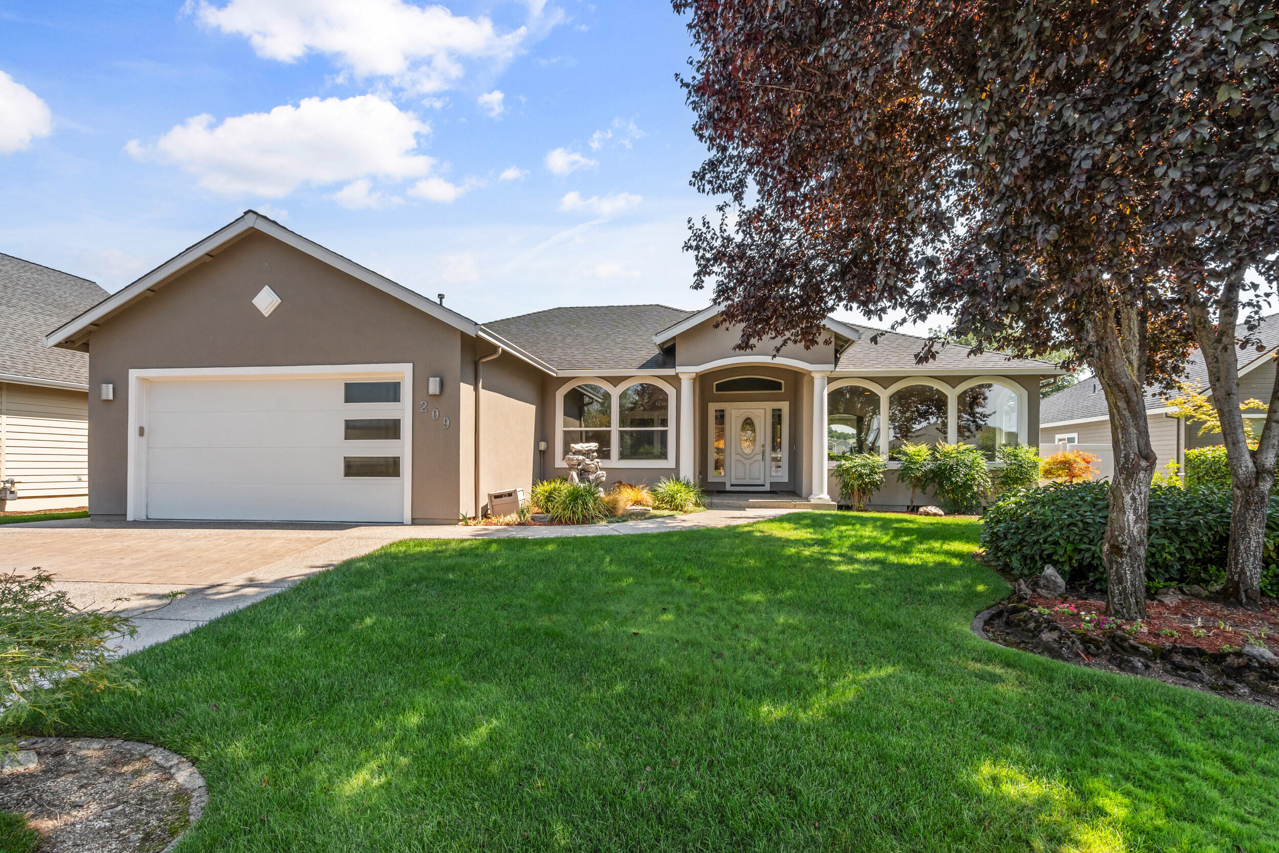 Boasting over $150,000 in premium upgrades—including a brand-new furnace and air conditioner—this beautiful 3-bedroom, 2-bathroom haven is perfectly positioned on the 7th fairway of the prestigious Eagle Point Golf & Country Club. Step inside to an elegant 1,930-square-foot living space with rich Brazilian cherry hardwood floors, soaring 9-foot ceilings throughout, and a dramatic 12-foot vaulted ceiling in the main living area that bathes the home in light and airy openness.  The open-concept kitchen is an entertainer's delight, outfitted with sleek stainless-steel appliances, built-in ovens, and a smooth glass cooktop—ideal for family dinners or dazzling guests. The primary suite offers a true retreat, featuring custom upgrades, heated tile flooring, and ample storage for ultimate comfort.  Every window has been replaced for energy efficiency, with motorized blinds providing effortless light control. Step out to a lush professionally landscaped grounds and a fully fenced backyard.