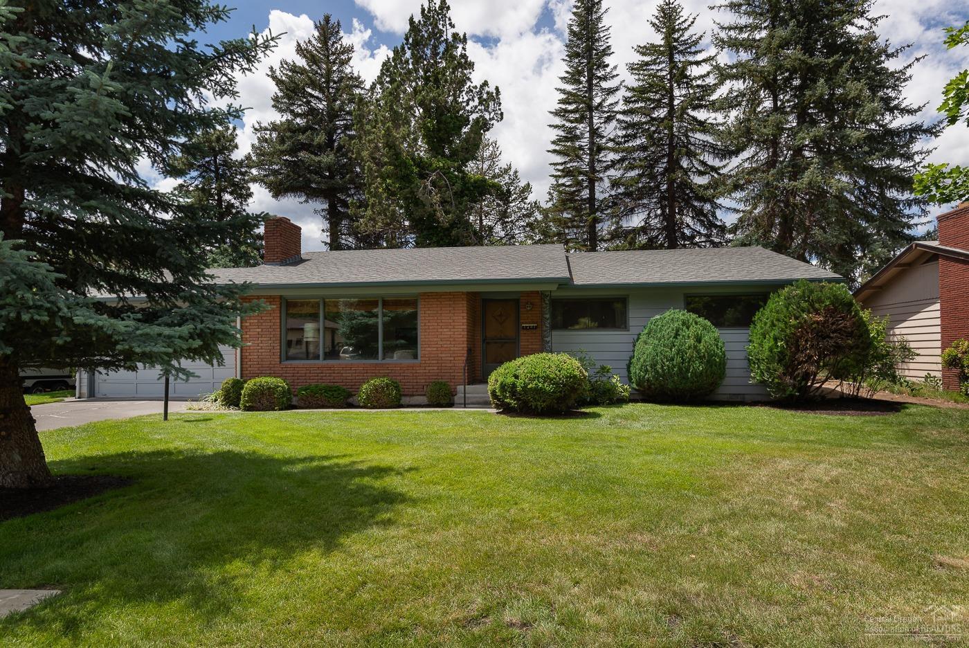 Mid-town charmer! This well maintained 1962 original is close to downtown, restaurants, parks and all the amenities of the Greenwood corridor. A wood burning brick fireplace and wood accents throughout keep the tone of the era. The exterior boast brick accents, two car- garage, established landscaping with a new roof and sprinkler system. A Must See!