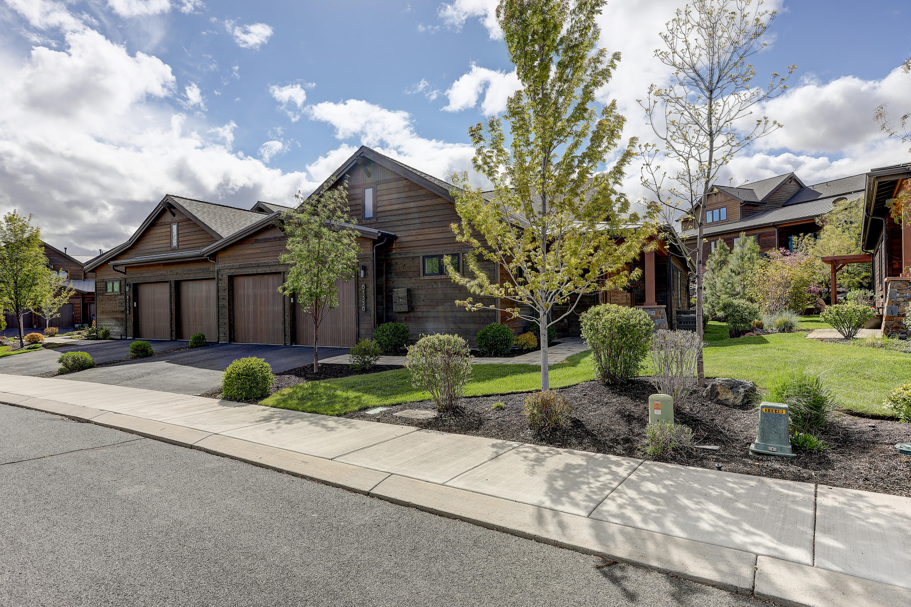 Wonderful single level, easy living townhome in Bend's most desirable Golf Course Community. Previous model home with no detail spared! Tour of Homes Best Kitchen, Best Interior Finish, Best of Show, and Best Feature of Outdoor Living Space. Extensive upgrades including Dansk Oregon Dunes Low Maintenance Hardwood Flooring throughout, Whirlpool Central Water Filtration System, remote control power window coverings & gas fireplace. Chef's kitchen with double islands, gorgeous cabinetry, s/s Jenn-Air appliances, quartz counter tops, wine cooler & open to the beamed vaulted great room. Nice separation of guest & owner bedroom suites. Large windows in owners suite brings the beautiful outdoor landscaping in. Great room French Doors open to the award winning paver patio, pergola & setting. All topped off with an oversized 562 Sq Ft garage, 22 feet in parking length