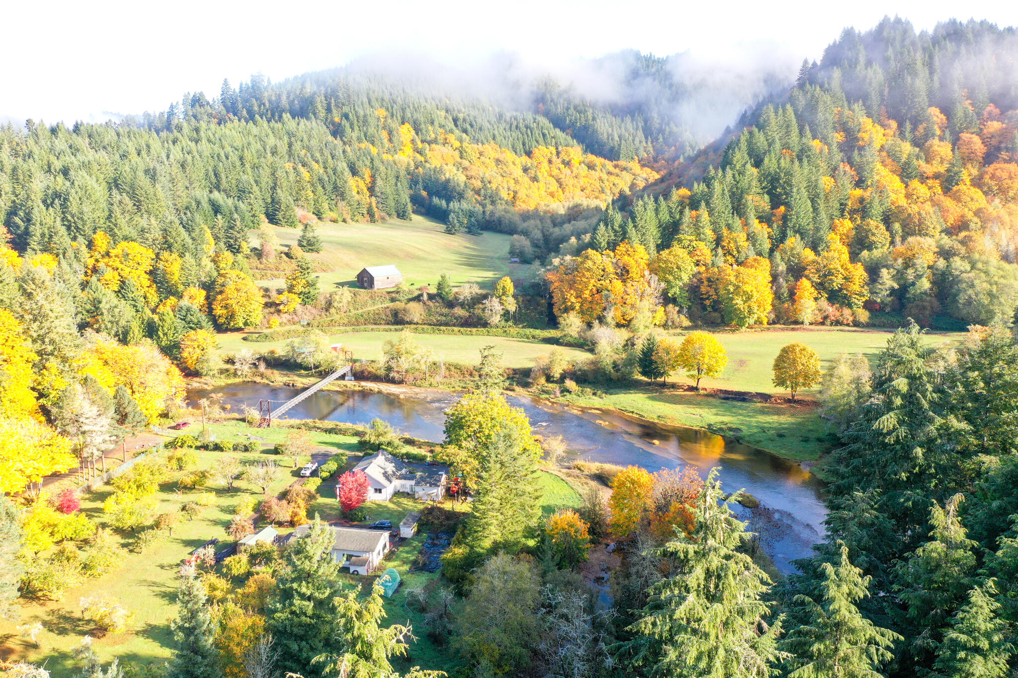 Located on the Smith River in Oregon, this one-of-a-kind property has so much to offer! 270 acres of beautiful pastures, an orchard, merchantable timber, and meadows alive with wildlife. With the Smith River running through the property, hunting and fishing is an outdoorsman's dream...watch the salmon run just steps from your door! Nestled safely above the river is a well appointed 4bed/2bath home with a 3-bay garage/shop. Outdoor living is a delight as you listen to the sound of live water from your patio or sit under the shade of an old growth tree nearby. Take a stroll across the suspended walking bridge which spans across the river or drive across the river over a natural rock ford that has been used throughout its history to a beautiful 2-level restored barn, corrals, cascading waterfalls and two year round creeks. Tucked away for privacy is a well crafted 2 bedroom guest cabin. Boasting unparalleled serenity & privacy come and see what makes this property so special. LOP tags