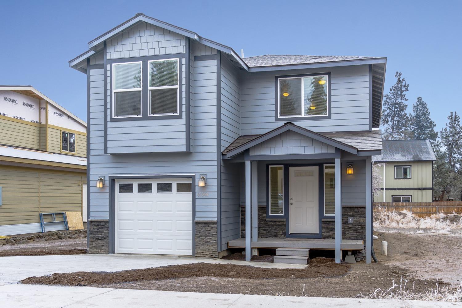 Brand New home in SE Bend - all the upgrades & RV parking too! Modern color palette in this turn key home from the open entry way & beyond. Kitchen w/multi level island, Granite counters, tumbled Travertine backsplash, SS under mount sink & sleek Stainless appliances. Laminate flooring throughout main level, plush carpet upstairs. Open loft /office area, great Master separation, Mstr bath w/dbl sinks & plenty of storage. Front entry w/2 closets & half bath. Trex decks, RV Parking or huge yard - don't miss!