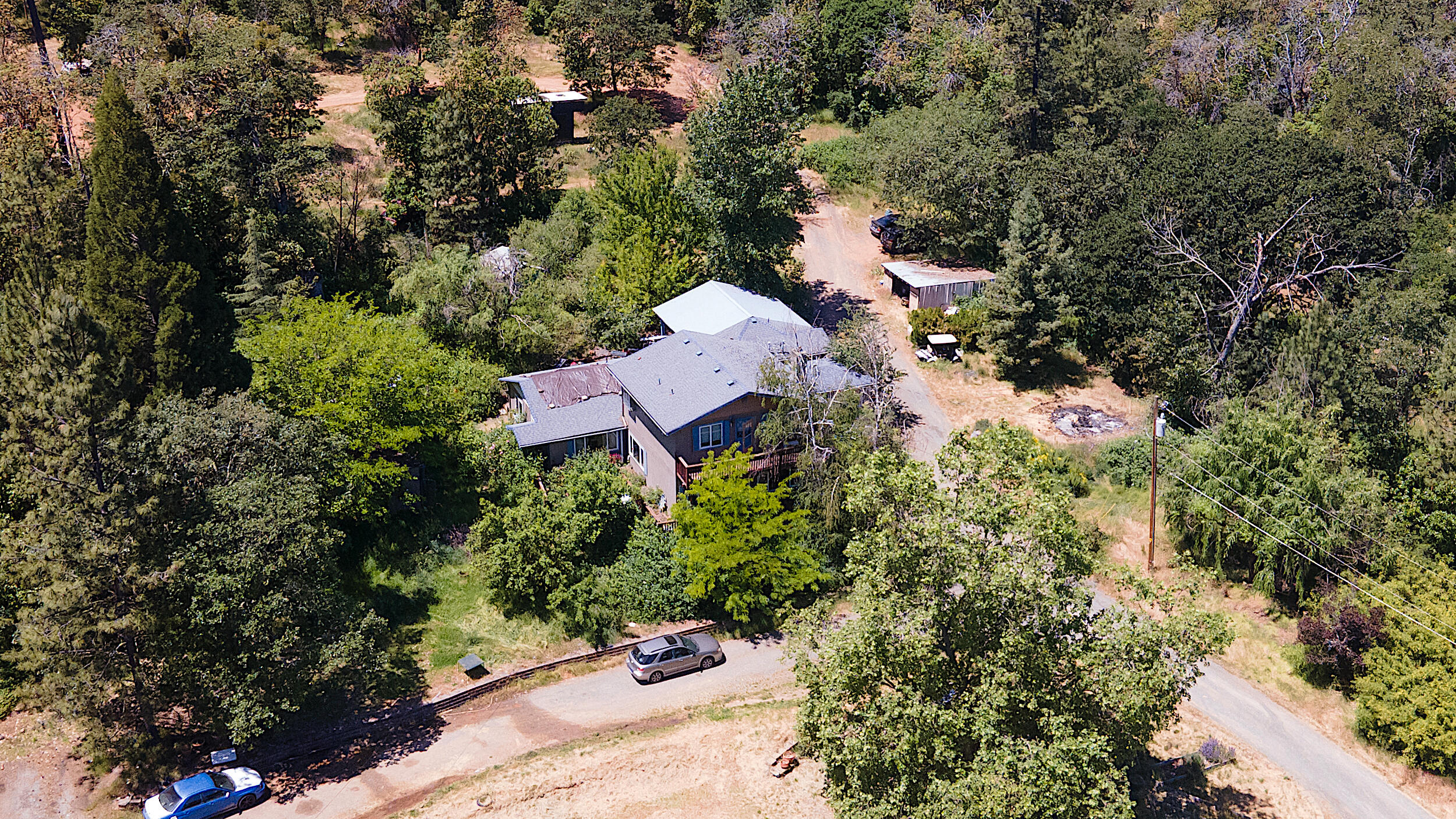 Incredible two-family setup on 30+ acres backing to BLM with stunning views of irrigated pasture and mountains. The 2,340 sq. ft. main home features two bedrooms downstairs and a spacious primary suite upstairs. The second, a grandfathered-in 1,201 sq. ft. home has vinyl windows and light updates - great for guests, in-laws, or rental income. A large detached garage/shop (800 sq. ft. with ADU potential), barn, and over 11 acres fenced and cross-fenced make this ideal for animals or hobby farming. Endless potential! Remodel, build new, or enjoy as-is. Priced to sell!