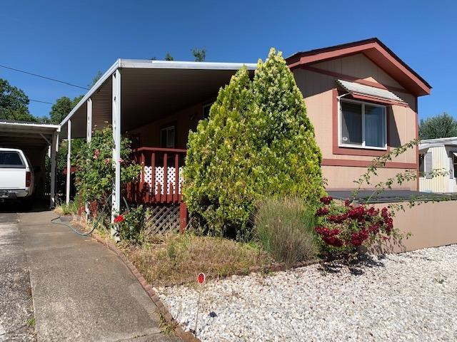 Double Delight! This 2 bdrm, 1 bath home in Royal Oaks, a popular 55+ park in Phoenix, has been seasoned with love and care. Here's a well-maintained 1992 single-wide with a great covered front porch. Enjoy views of the hills and trees from porch and front window. The home has vaulted ceilings and is sunny and clean. An open kitchen has a large island for meal prep that doubles as a breakfast bar. There is room in the kitchen for a table as well. Vinyl windows & new laminate flooring in the living room and hall show the care taken with this home. All the appliances stay in the home. The master bedroom is at the rear of the home. You'll find 2 sheds, 1 under the carport & 1 in the back yard. This is a low maintenance space with rose bushes. Space rent is $483/month including water, sewer & garbage. The park accepts one pet under 20 pounds. Good things do come in small packages. This is one of them.