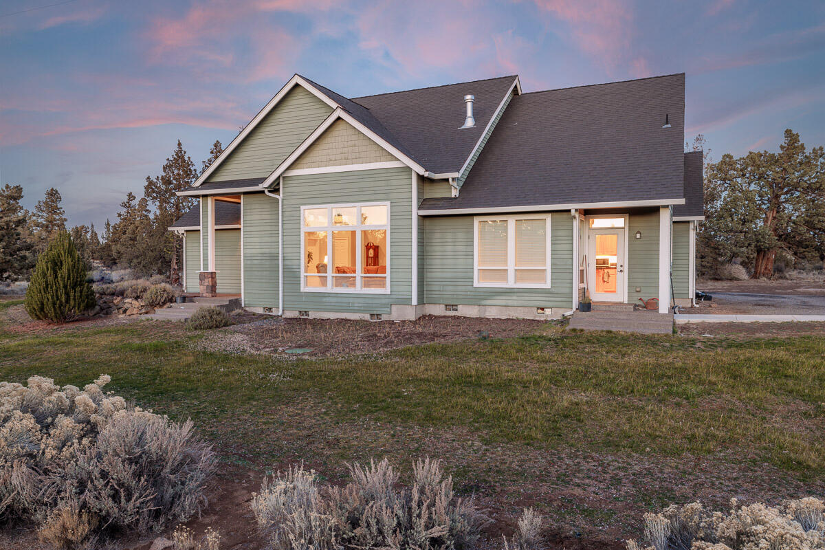 Traditional single level custom built home on flat acreage located between Bend and Redmond (near Boones Borough) with no HOA or CC&Rs.  This property has so so many possibilities. PeakAboo mountain views welcome you. Come in to a tile entryway and soaring (over 12'' tall) ceilings. This home comes furnished.  Propane fueled fireplace, central heat, water heater and cooktop.  The kitchen features alder cabinets and sand-in-place floors, a spacious island and granite tile counters.  Elegant wainscotted dining room.  All three bedrooms are separated. First  Primary bedroom has a vaulted ceiling, walk-in closet and ceiling fan.  first Primary bath includes a jetted tub, water closet, dual sinks and a skylight.  Laundry room with sink and ample storage and central vac.  Detached double car shop, polished concrete floors, 1/3 of which is heated and sheet-rocked. Shop has power and frost free hydrants in front and rear. Peek-a-boo mountain views.