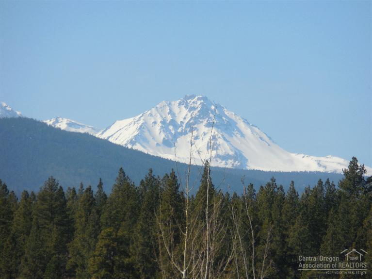 Rare, private lot in Shevlin Commons. Very desirable area with excellent view of Cascade Mountains. Includes community center for homeowner events and facilities. Indoor/outdoor gas bar-b-q, gas fireplace, dining and kitchen facilities, paved walkways, nature trails to nearby Shevlin Park and Tumalo Creek. Trails have unobstructed view of Cascade Mountains and large public land areas.