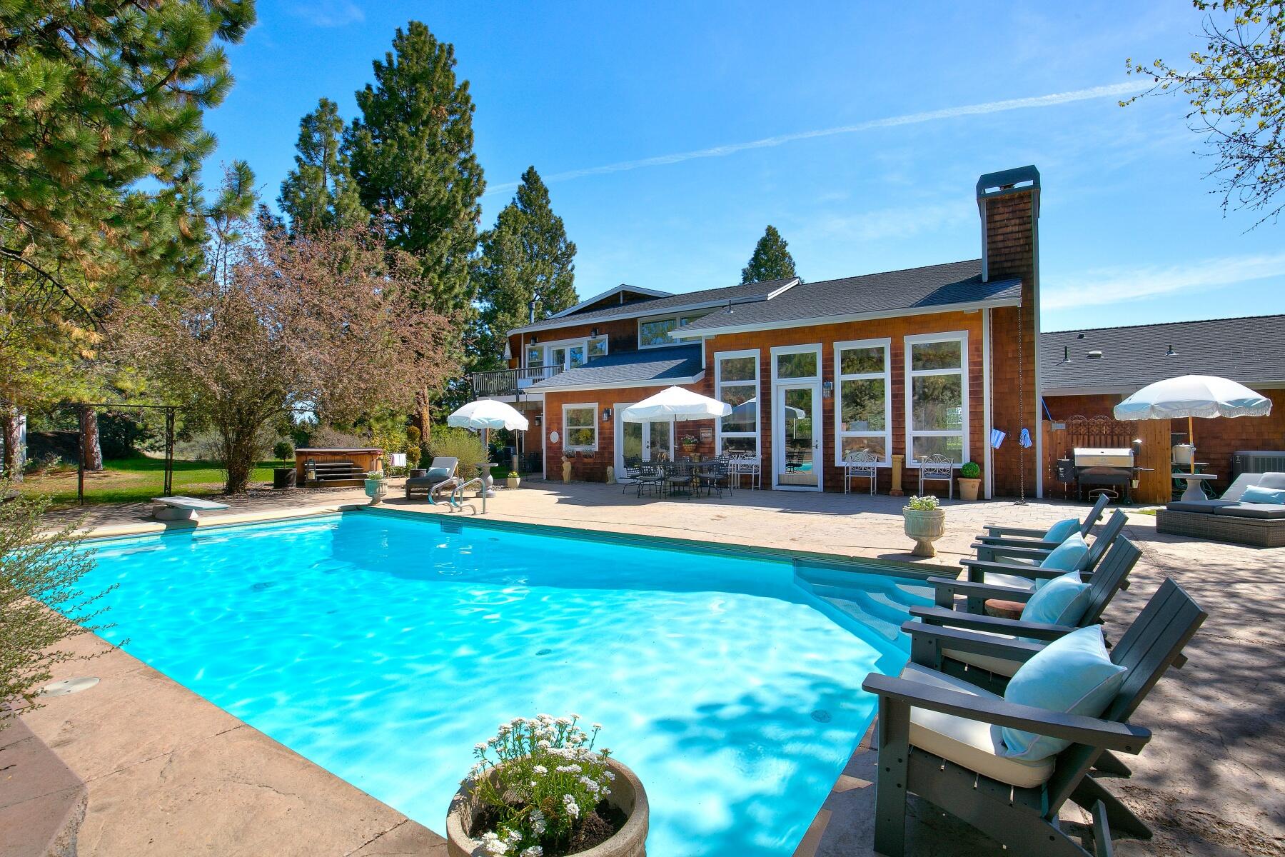 This country estate on 3.68 acres offers a private park like setting close to Bend. NW Style Custom Home is 4902 sq ft, 4 bedrooms, 4.5 bathrooms. Great Room with open floor plan, vaulted ceilings, wood stove, natural light. Gourmet Kitchen with SS high end appliances, Wolf 48-inch cooktop, double ovens, granite countertops breakfast nook. Formal dining room with wet bar. Two offices: one in the home, one attached to garage with exterior entrance. Upstairs master suite with fireplace, private balcony and down stairs bedroom suite with private bath. Bonus/Game Room, large utility room, 3 car attached garage with work bench, storage. Outdoor living is perfect for entertaining with a salt water pool, gazebo, hot tub, tree house and garden area. Yard is landscaped and pastures that have 2 acres water rights and a sprinkler system, fenced, gated, paved driveway, close to public land and can have livestock. This property is wonderful opportunity to enjoy any Central Oregon lifestyle!