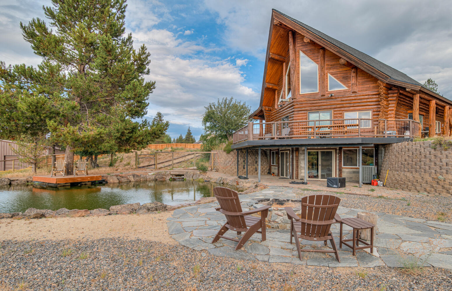 Riverfront retreat on 9.66 acres along the Little Deschutes! This stunning custom log home offers sweeping views of Mt. Bachelor, the Three Sisters, and Broken Top. Floor-to-ceiling windows frame breathtaking sunsets, wildlife, and your private oasis. The recently remodeled kitchen features new cabinets, counters, and appliances. Updated bathrooms and flooring throughout. The spacious lower level includes a large bonus room, while the loft offers its own bath and private deck—perfect for peaceful mornings. Step outside to a wraparound deck, patio, workshop, pond with dock, and beautiful landscaping with aspens and pines. Just minutes to Mt. Bachelor, Cascade Lakes, Sunriver, and Bend, this is the perfect blend of mountain serenity and Central Oregon adventure.