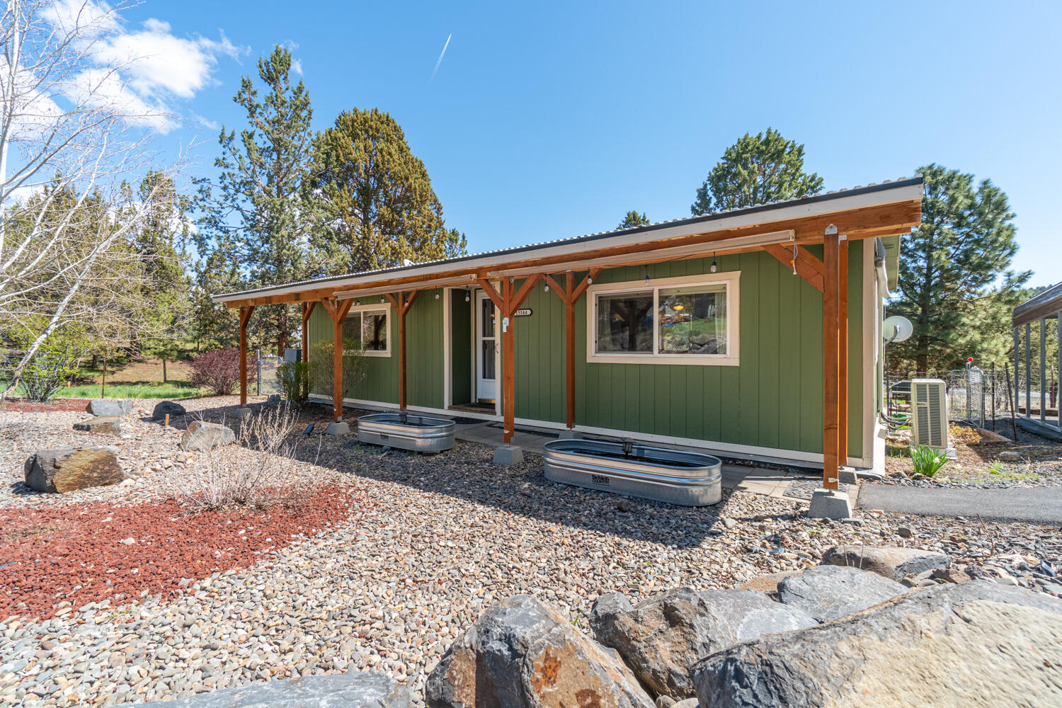 Don't miss this well maintained home on a half acre w/low maintenance landscaping & plenty of room for outdoor fun/activities!  Main living area is full of natural light w/plenty of room for entertaining. Kitchen is updated w/butcher block counter tops, appliances, plenty of cabinet space, & eating area that ftrs sliding doors to the beautiful covered back deck. Well sized primary bedroom + additional bedroom share a full bath. Laundry room w/storage built-ins off an exterior entryway. Step outside to your fully covered back deck that offers the perfect space for year round entertaining or quiet mornings watching the wild life. Fully fenced backyard w/trees, firepit, small storage shed & covered storage space. Large two car covered metal carport. Mitsubishi ductless heat pump, septic system & community water. Minutes to Prineville Reservoir, fishing, water sports & hunting. Enjoy plenty of space for outdoor activities, RV parking, at home garden, pets + critters, adventure toys & more.